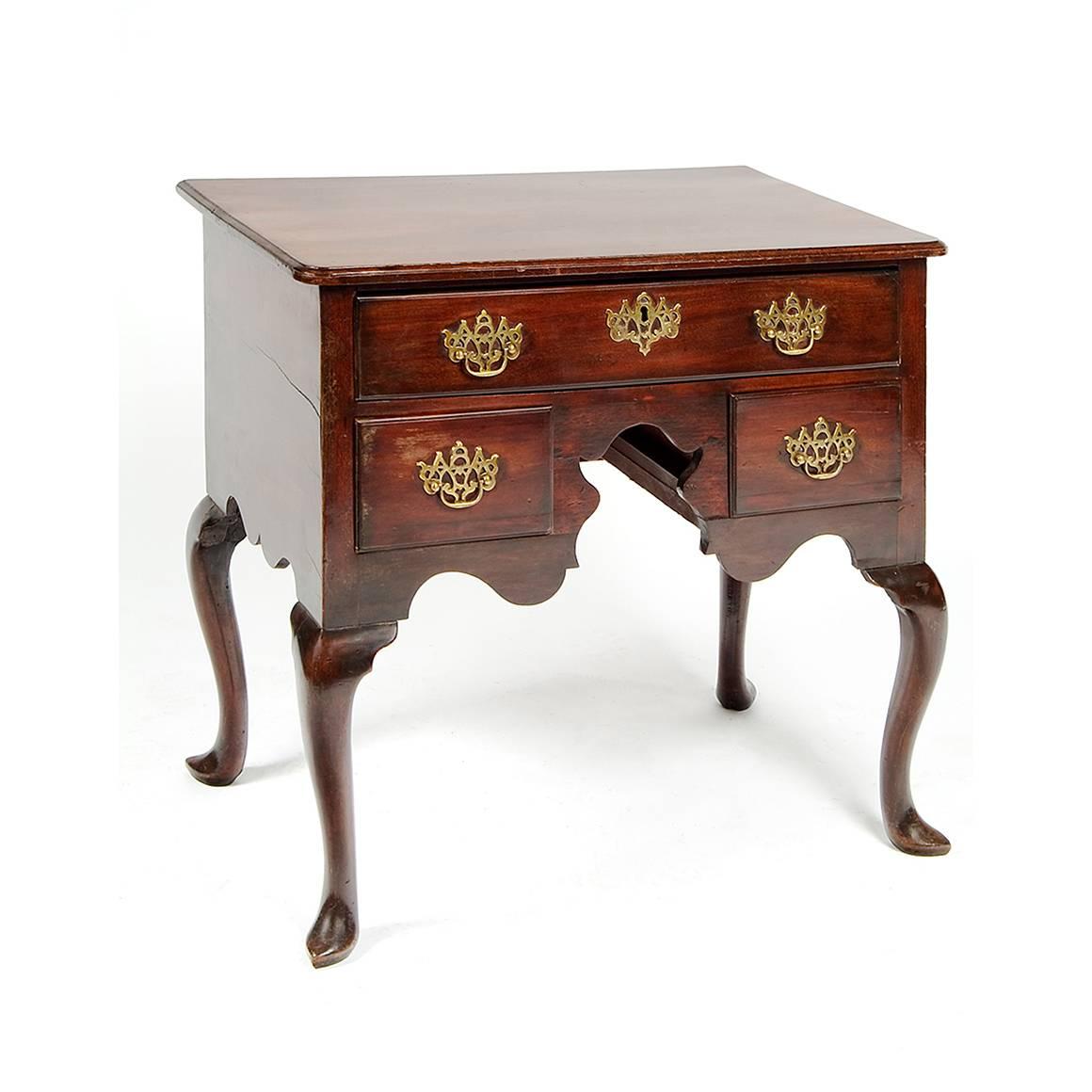 18th century mahogany low boy with cabriole legs and slipper feet. Consisting of one long and two short drawers, with original pierced batwing brass handles and escutcheon.