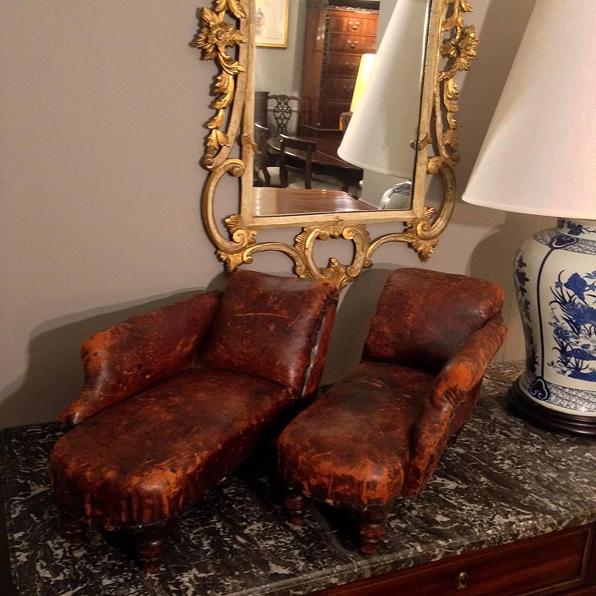 This very unusual pair of miniature French Second Empire méridienne chaise lounges were likely created as a sample or window advertisement by a chair maker. Each is upholstered in leather, on four turned legs.