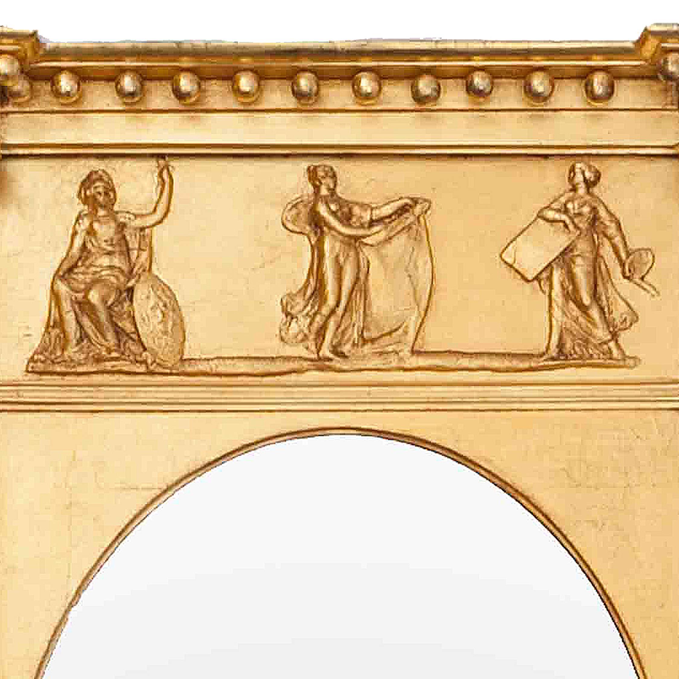 19th century carved giltwood mirror. The oval mirror plate within rectangular frame, surmounted by classical frieze with figures flanked by Reeded Pilasters.