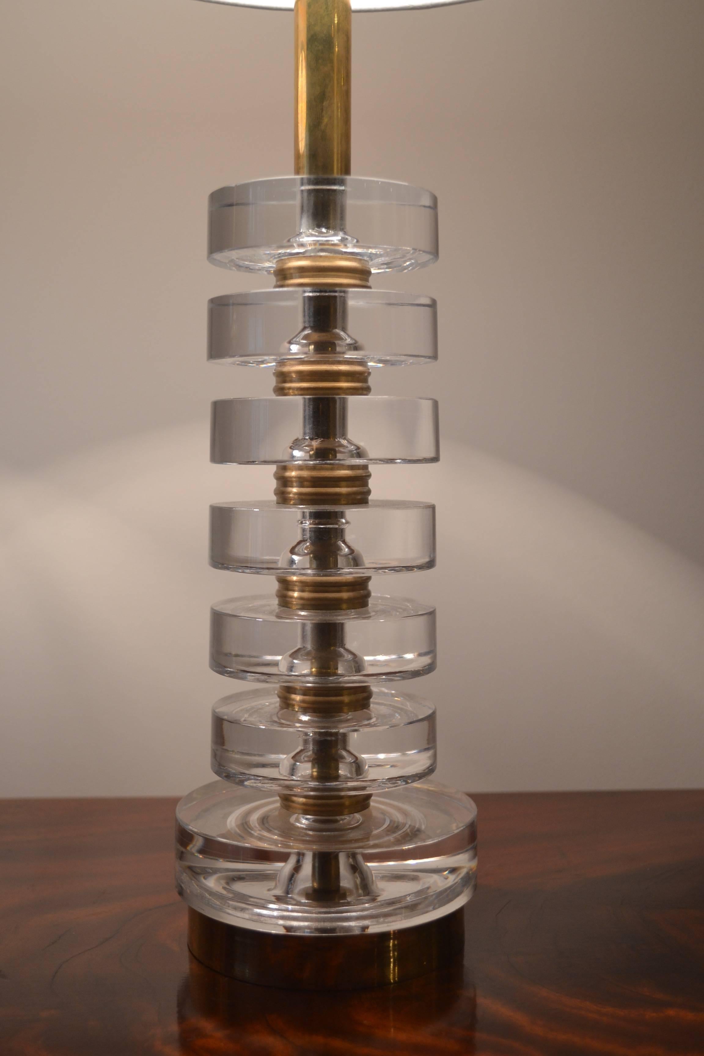 Pair of lamps in glass and brass by Carl Fagerlund for Orrefors, circa 1960s.
Stacked glass discs with brass details. Newly rewired with new shades.

18