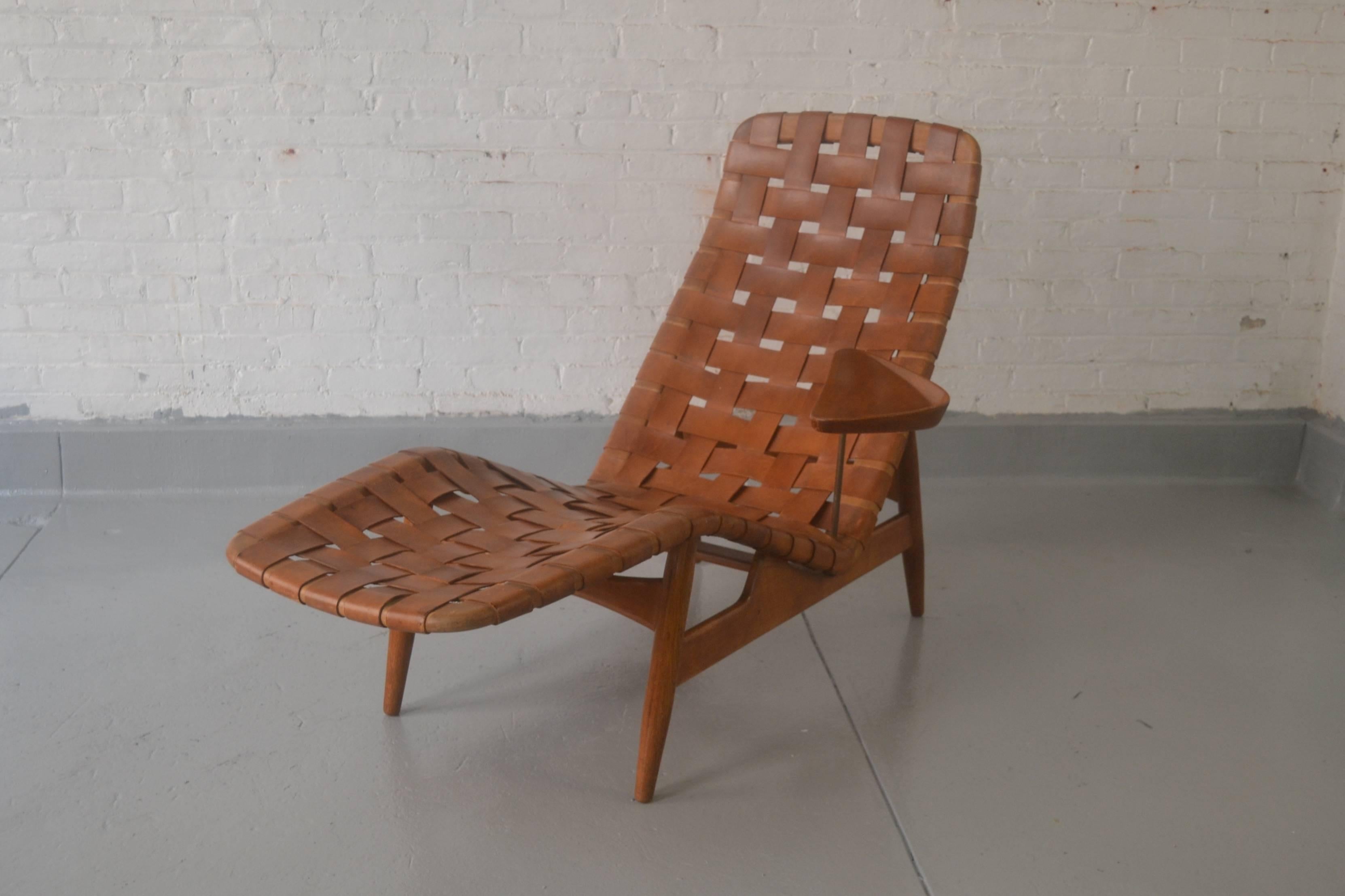 Rare sculptural chaise lounge by Arne Vodder, Denmark, 1950s. Original leather strapping with beautiful patina on teak frame with original tray table. Excellent condition with normal signs of wear.

Measures: 38 in. H x 54 in. W x 22 in. D.
Seat: