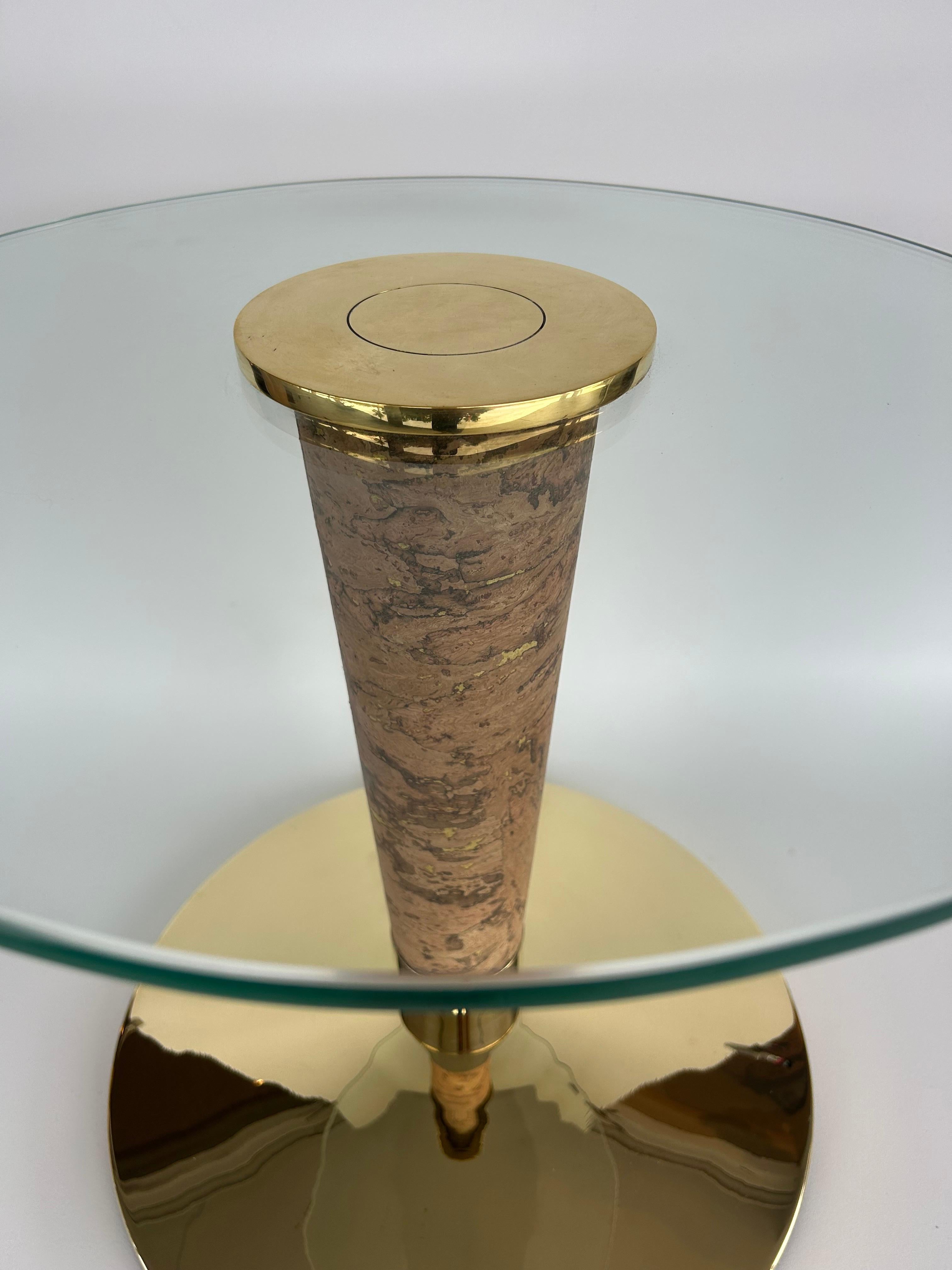 A restored drinks table or side table . Period italian design of the midcentury period. I believe this piece has a clasic / neoclassical inspiration as well.
I have reimagined and updated the table by wrapping it in cork and polishing the brass.
I
