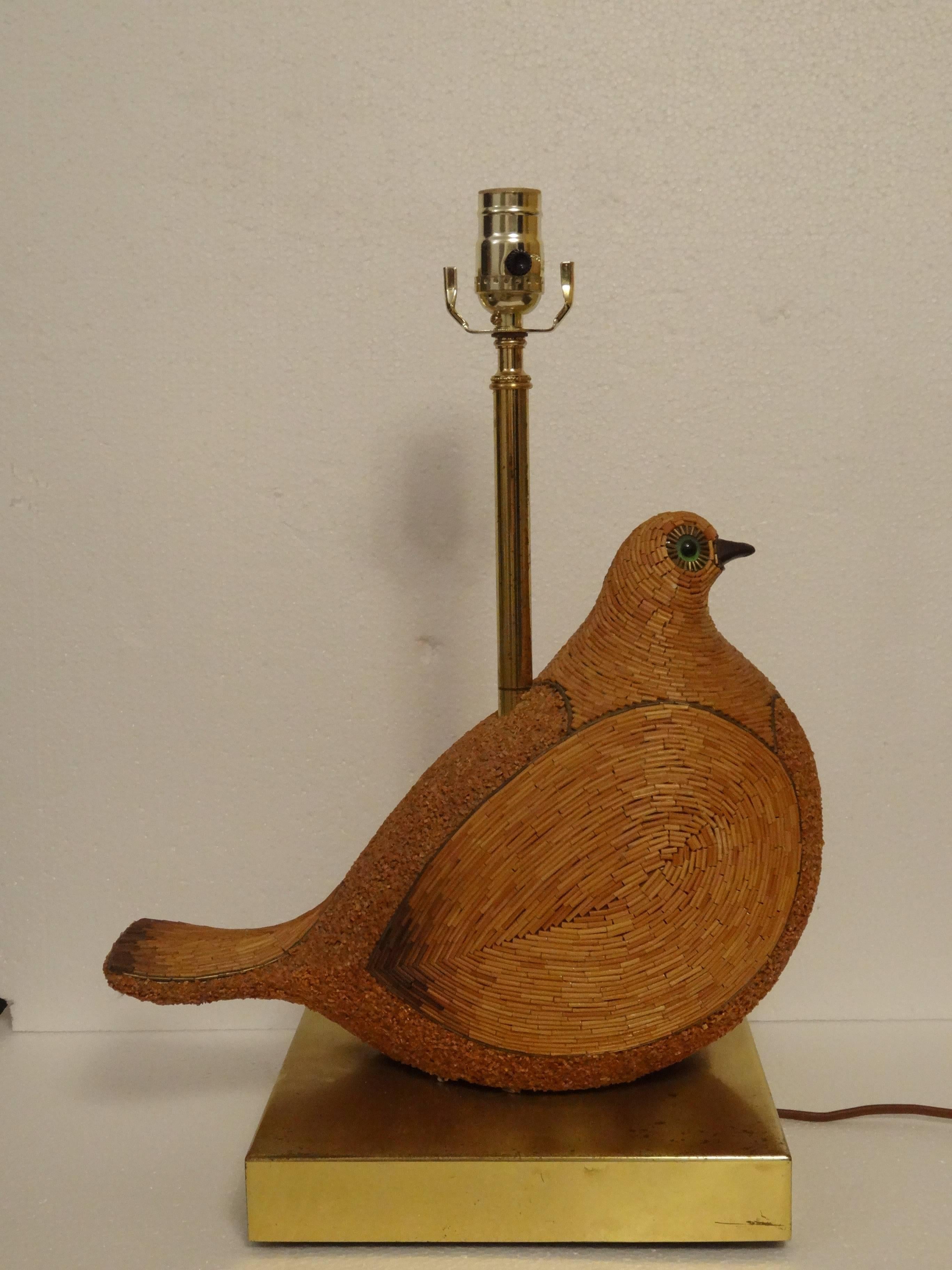 A rare an unusual lamp in the form of a dove.
This lamp has been hand fitted with reed and inlaid with brass.
Incredible detail and craftsmanship in creating this work.
The brass plated metal base compliments the sculpture and materials