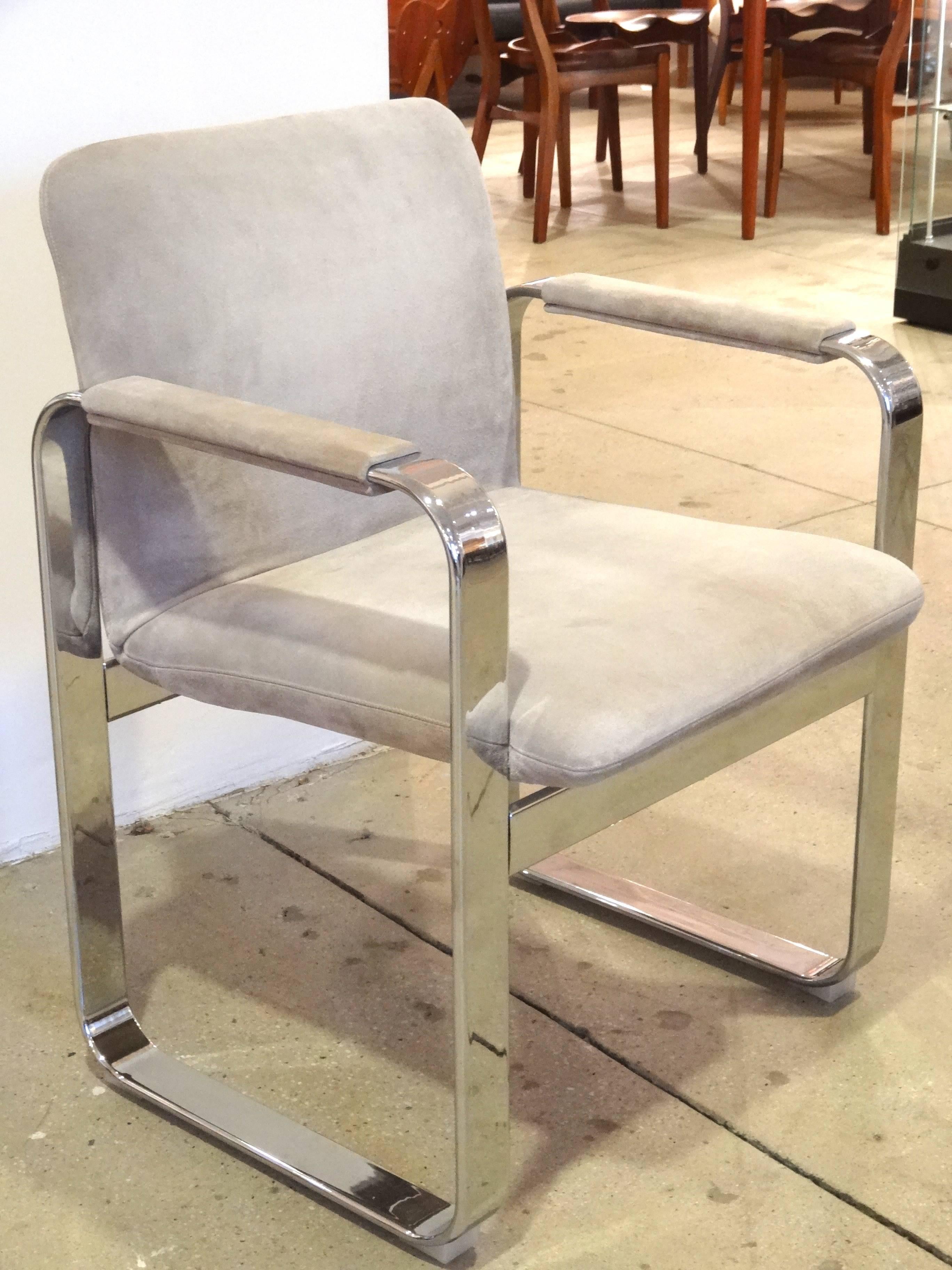 A pair of beautifully designed armchairs.
Clean modern lines highlighted by the nickel finished and neutral tone upholstery.
Italy stamp on underside.
Measures: Arm height is approximate 26