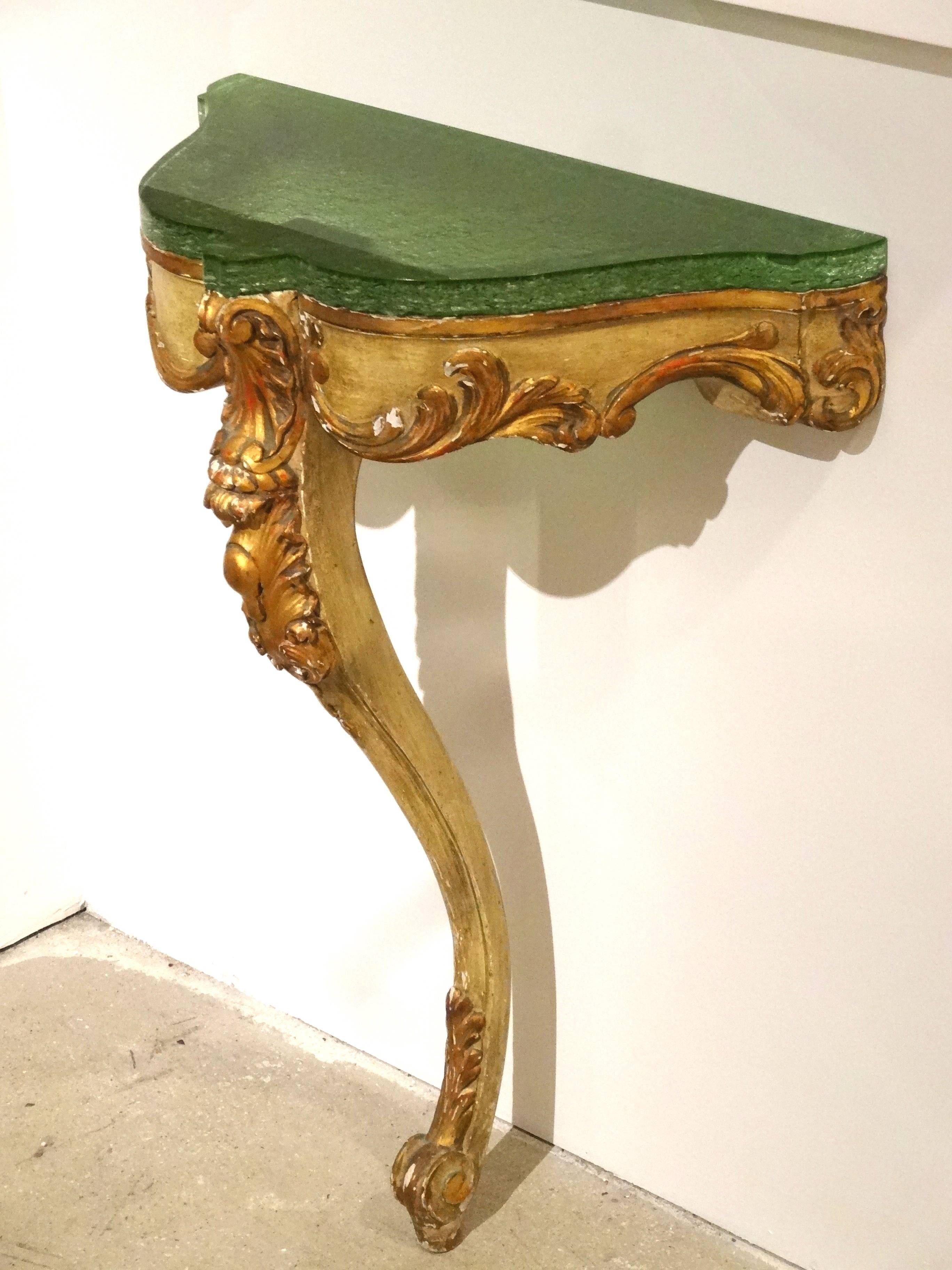 A beautifully aged painted and gilded console with a new modern custom Lucite top.
Nicely carved details which are highlighted by the gilding.
The modern colored Lucite slab add a bit of modern complimenting the classic form.