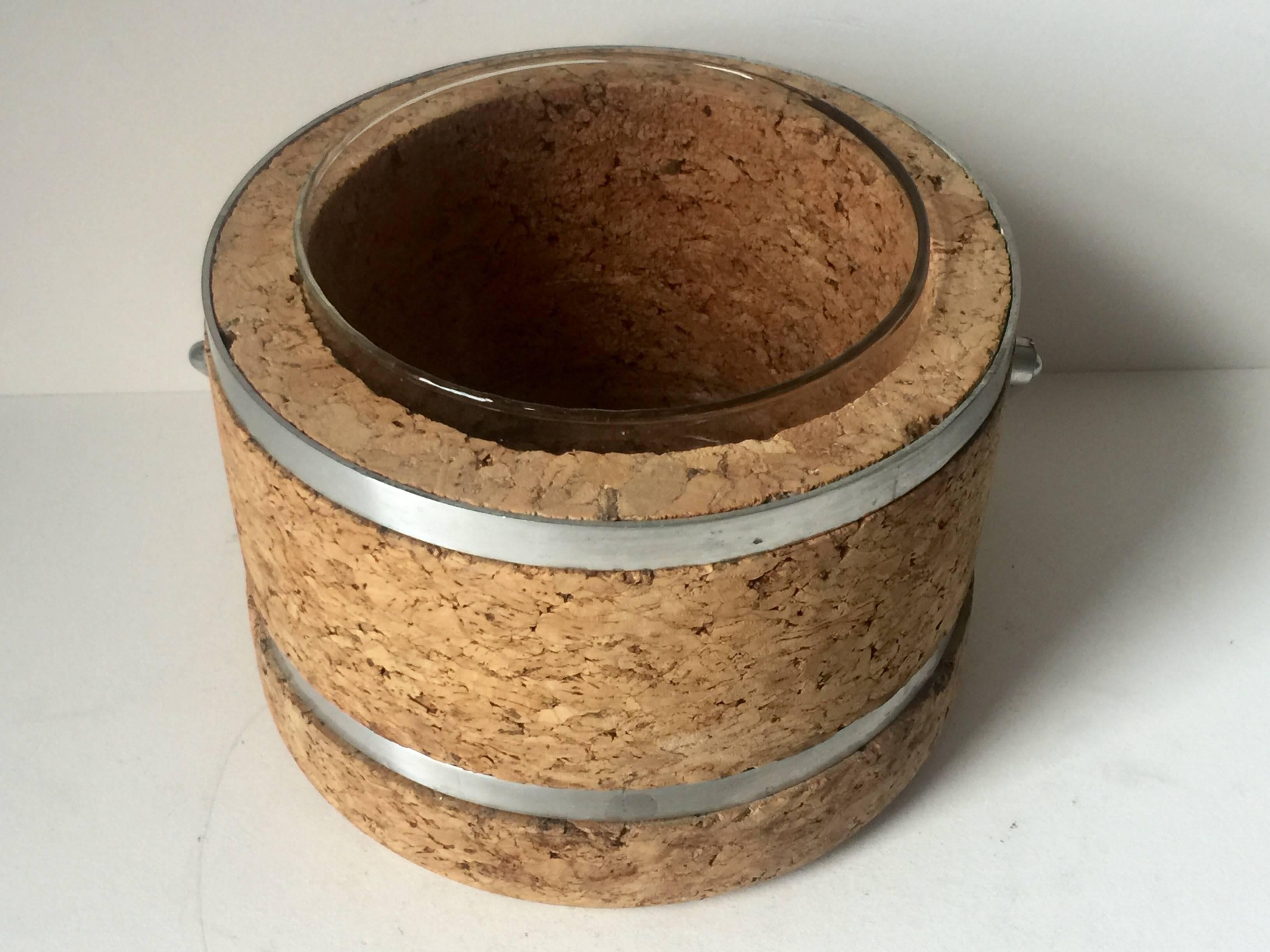 Cork and metal ice bucket with glass cup inside. 