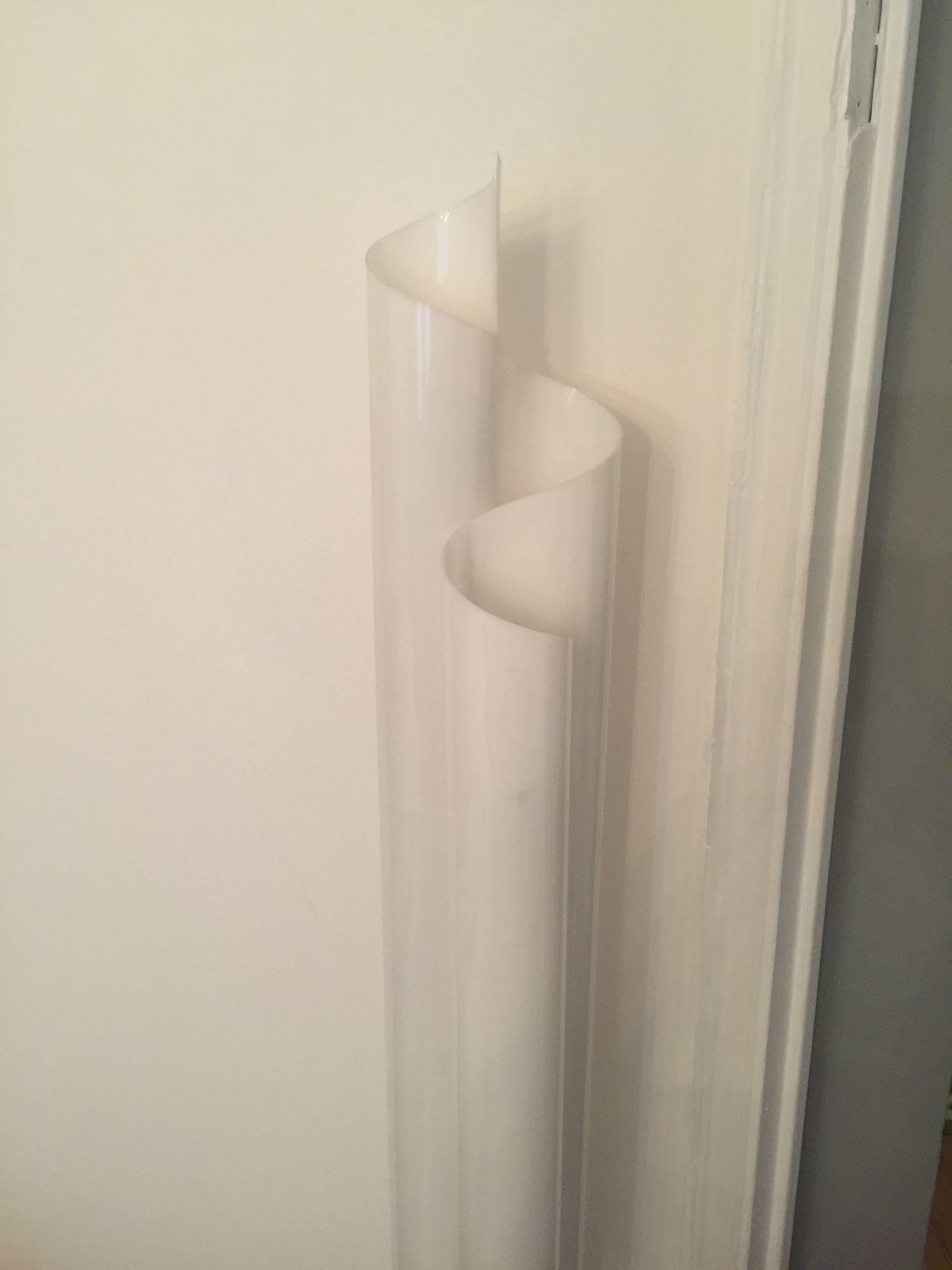 A plexi floor lamp which has a folded design which is molded feom one piece of plexi.