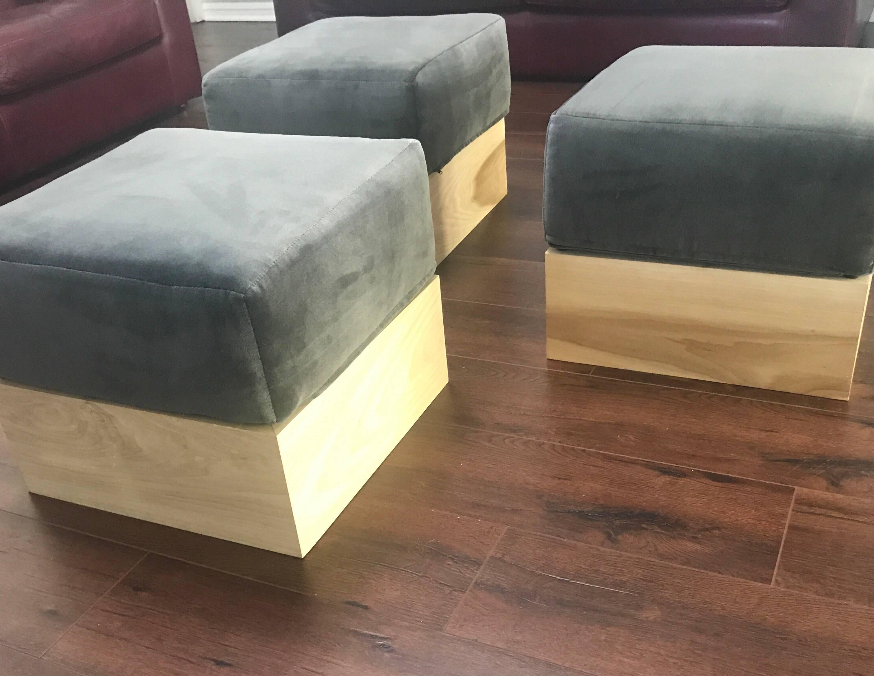 An early set of Modernist utilitarian solid square birch ottomans with plush smoked gray cotton upholstery made by the Haas Brothers for A Hollywood production company The ottomans were part of one of their first commissions for an entertainment
