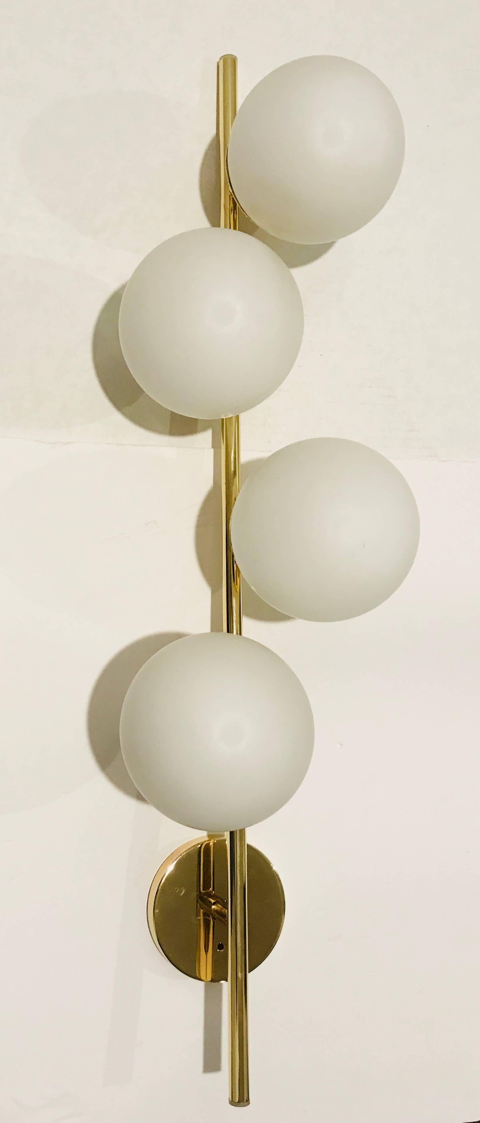 A large 1960s Italian midcentury polished brass and white frosted glass globe wall light. Newly rewired.