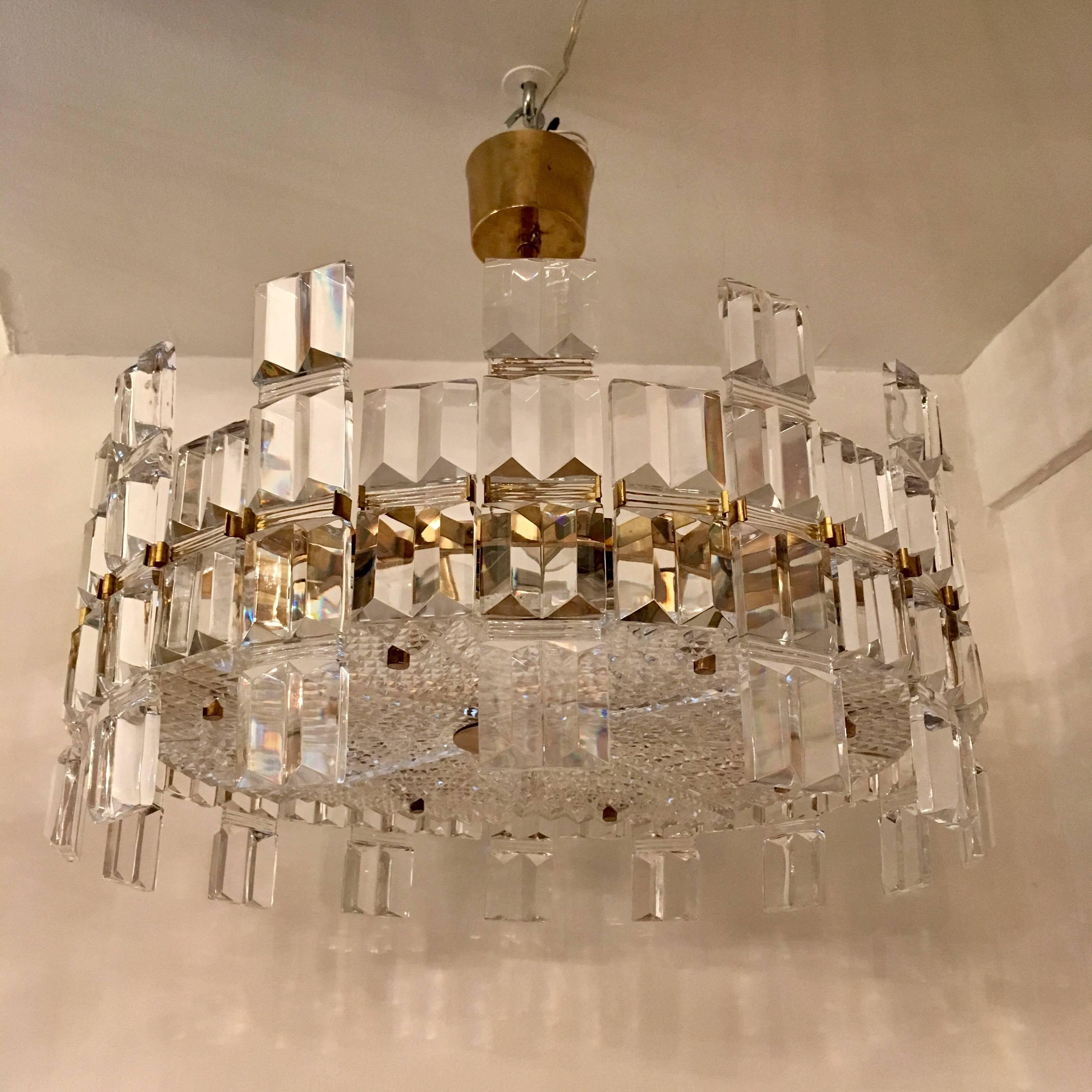 A beautiful luxurious thick crystal and polished brass chandelier by the famed Swedish maker, Orrefors. Rare. Eight light sources. Newly Rewired. Located in our New York City Chelsea location.