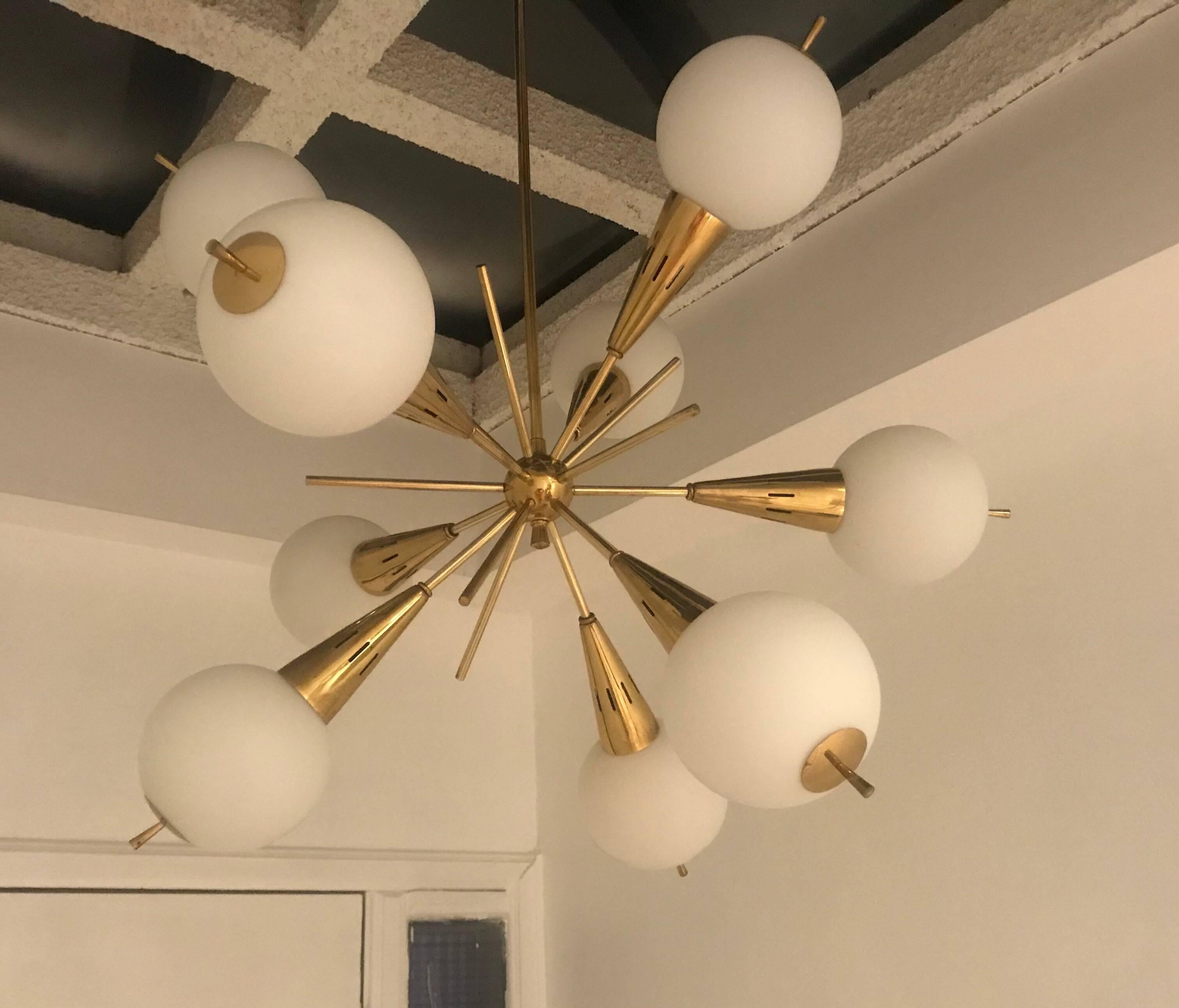 An original Italian pendant composed of a golden ages brass body with jutting rods and white glass globes forming an unusual Sputnik style. Newly rewired.Located in our New York City Chelsea location.