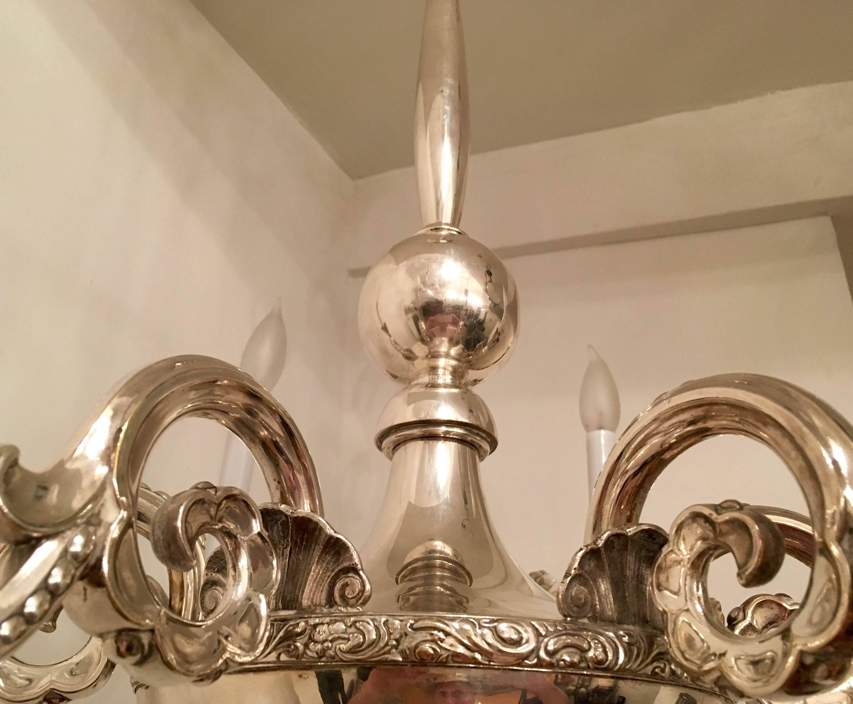 A wonderful original 1920s Grace period Swedish silver plated six arm chandelier designed by Elis Bergh for CG Hallberg. Newly rewired. Signed with makers marks. A second chandelier available.