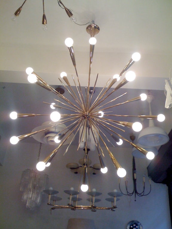 A 1960s Italian brass starburst chandelier. 24 light sources. Rewired and reconditioned. They came out of an Italian holiday resort. Two available.