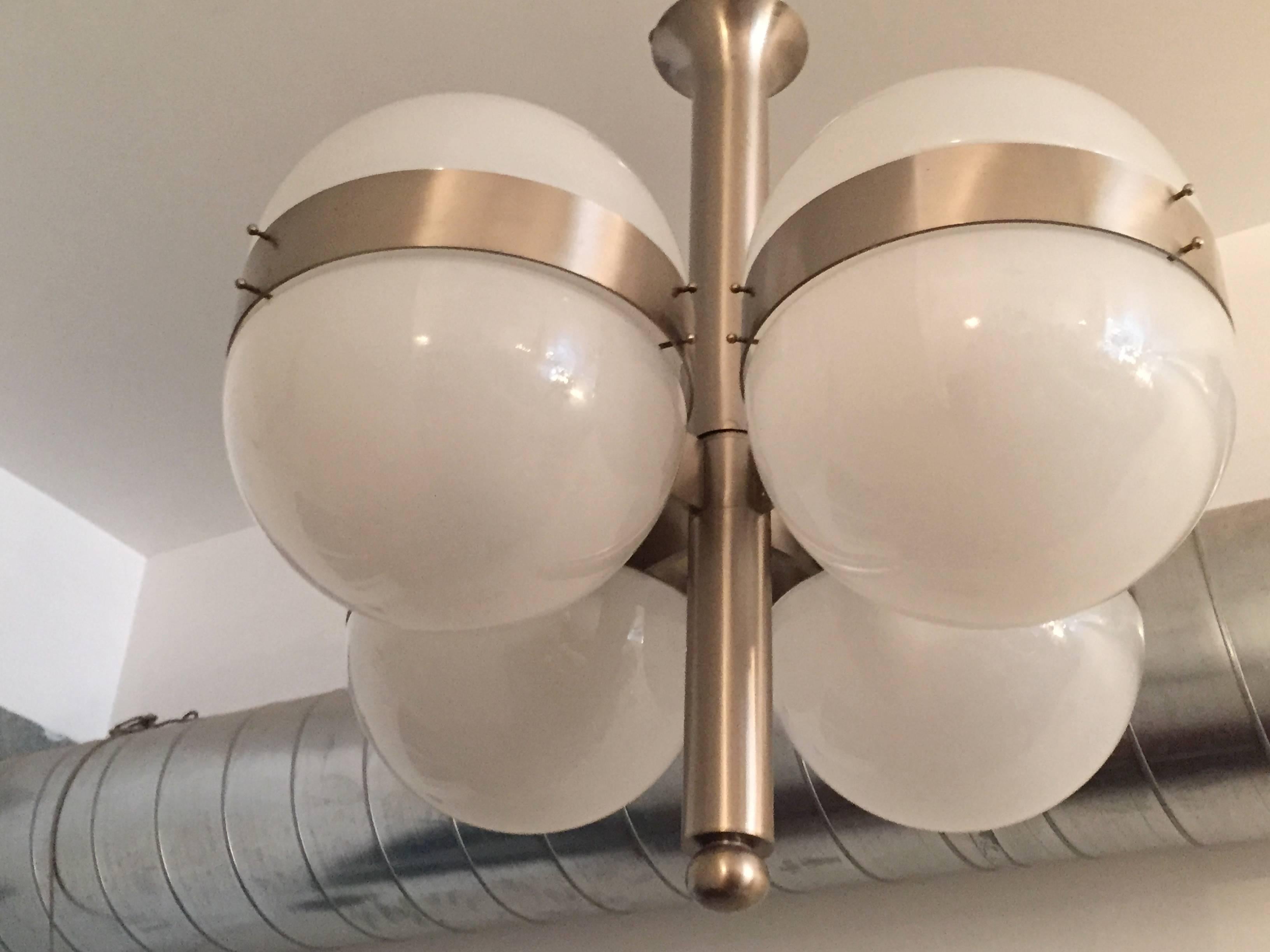 A sleek pair of  modern Italian, 1970s ceiling or hanging pendants composed of a brushed steel fixture with eight opaline glass dome shades. Made by Sergio Mazza for Artemide. Rewired. Matching wall lights.