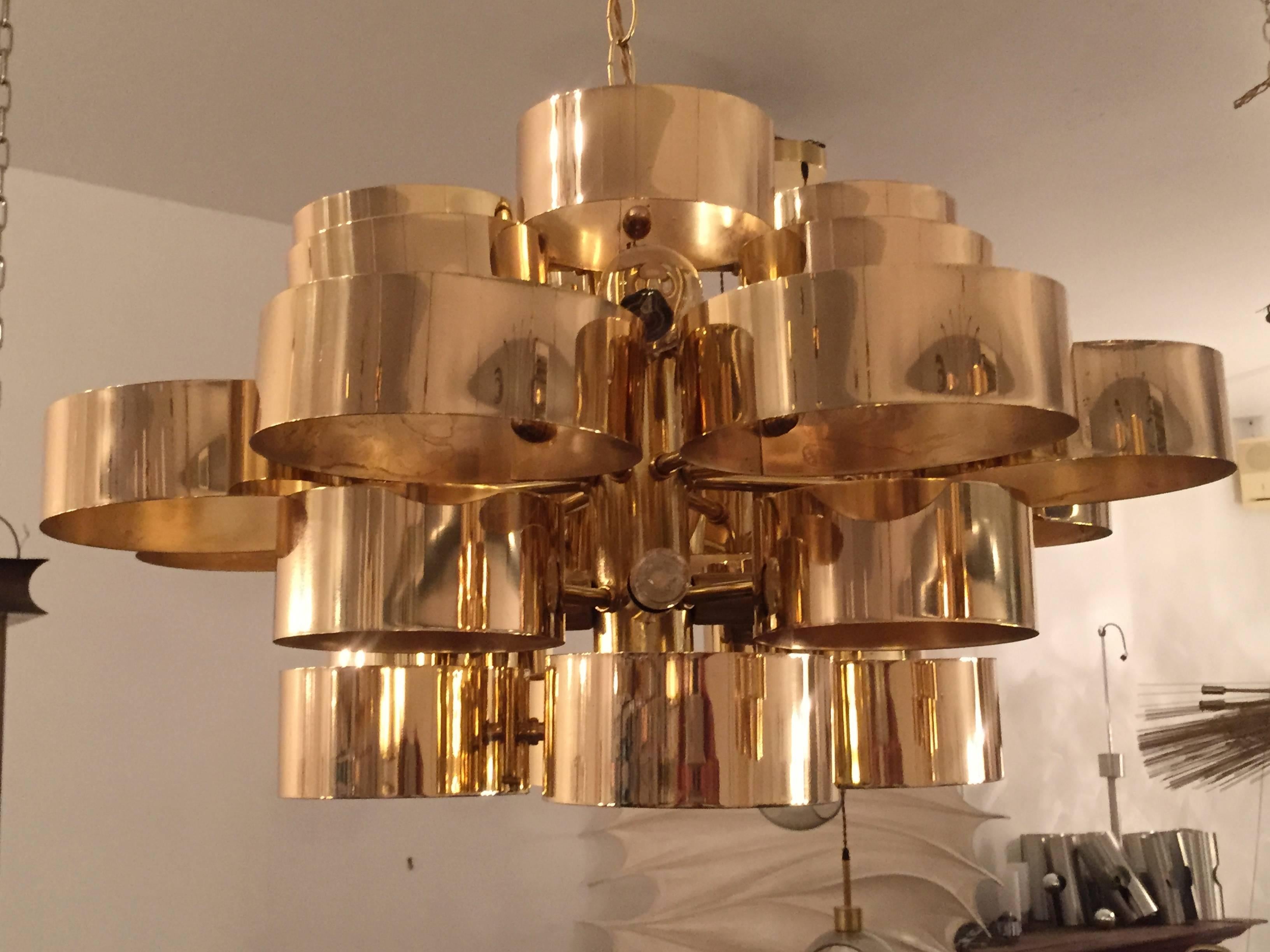 A wonderful pair of 1970s American Mid-Century Modern polished brass pendant chandeliers. Signed. Rewired. 13