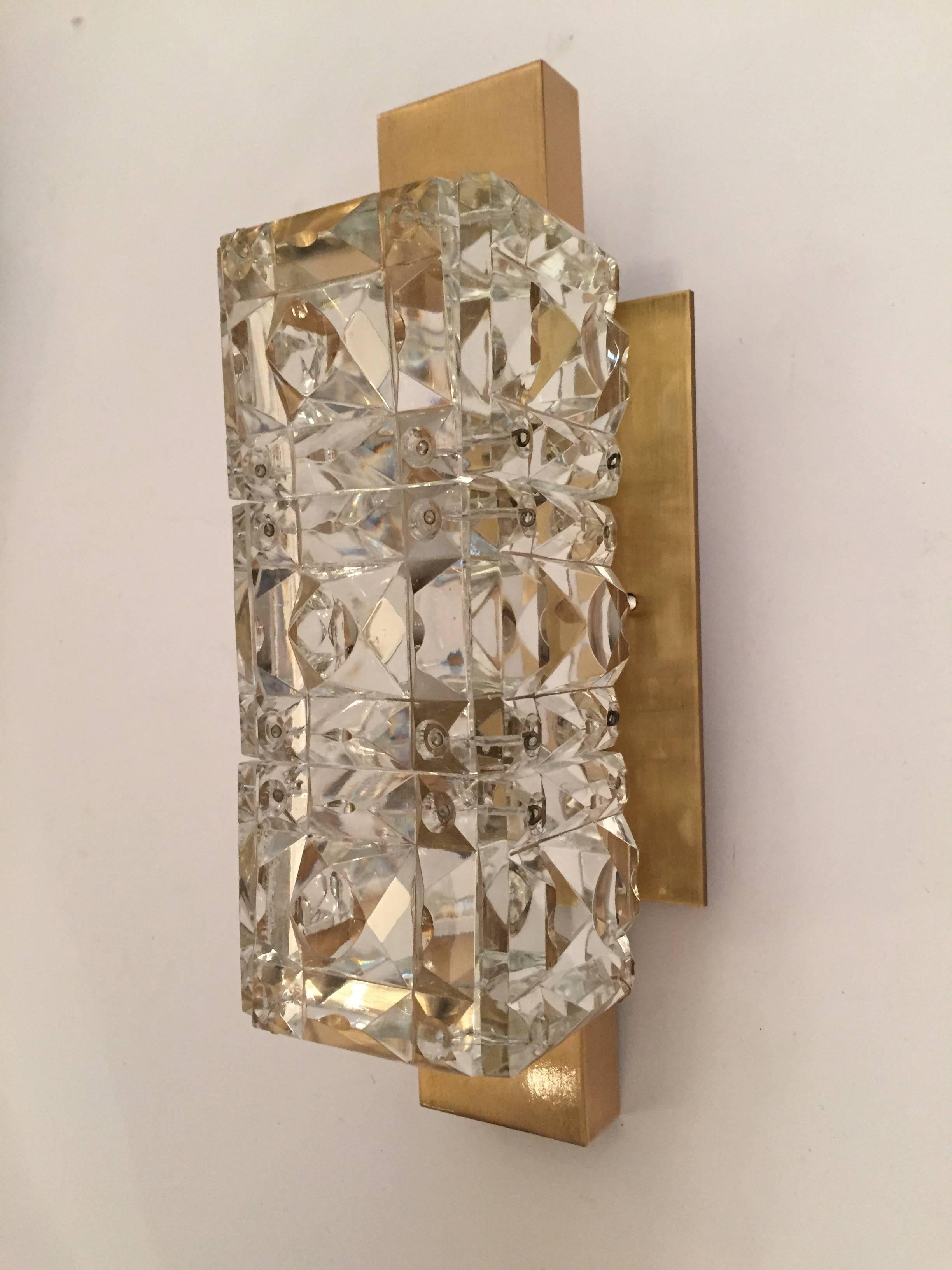 A pair of luxurious heavy Austrian crystal wall lights by the famed maker. Kinkeldey. The sparkly sconces have have brished satin brass backings which cover the standard electrical box. Rewired.