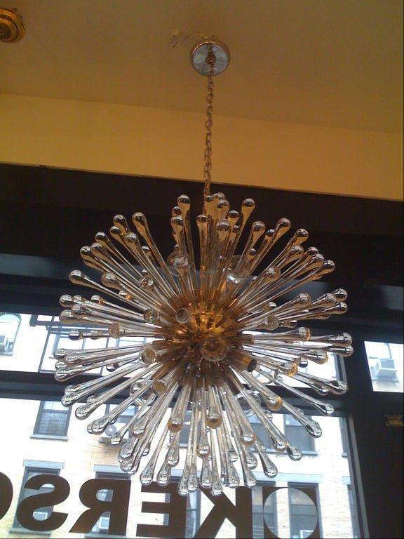A 1960s Italian glass and nickel chandelier. The polished nickel frame has nine lights and 150 teardrop glass elements radiating from the center. Matching canopy.