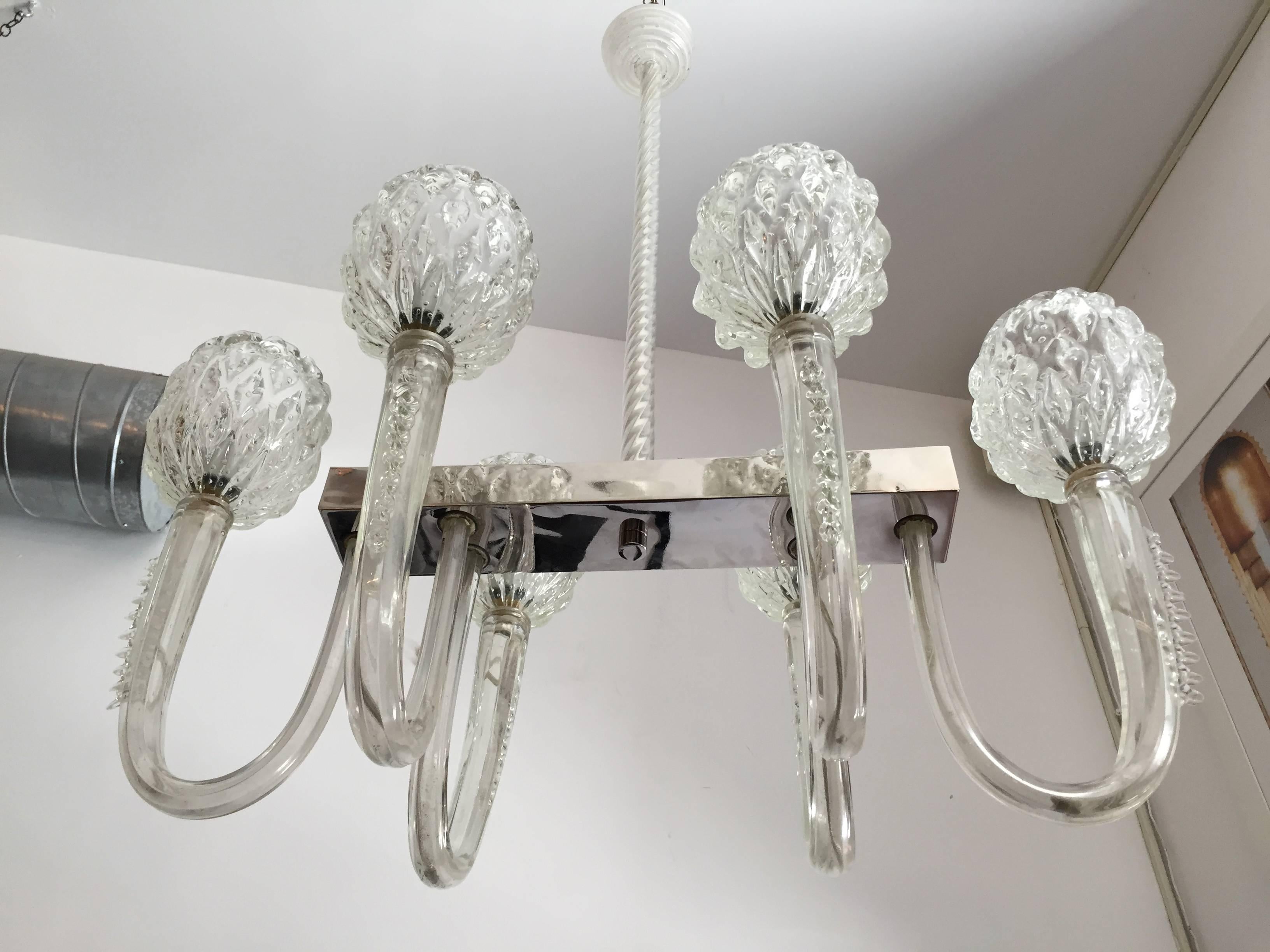 An elegant 1940s Italian Murano glass chandelier composed of a polished nickel body and thick handblown Venetian clear glass arms and shades by Barovier and Toso. Each of the arms weigh over ten pounds. A rare Murano chandelier of this exceptional