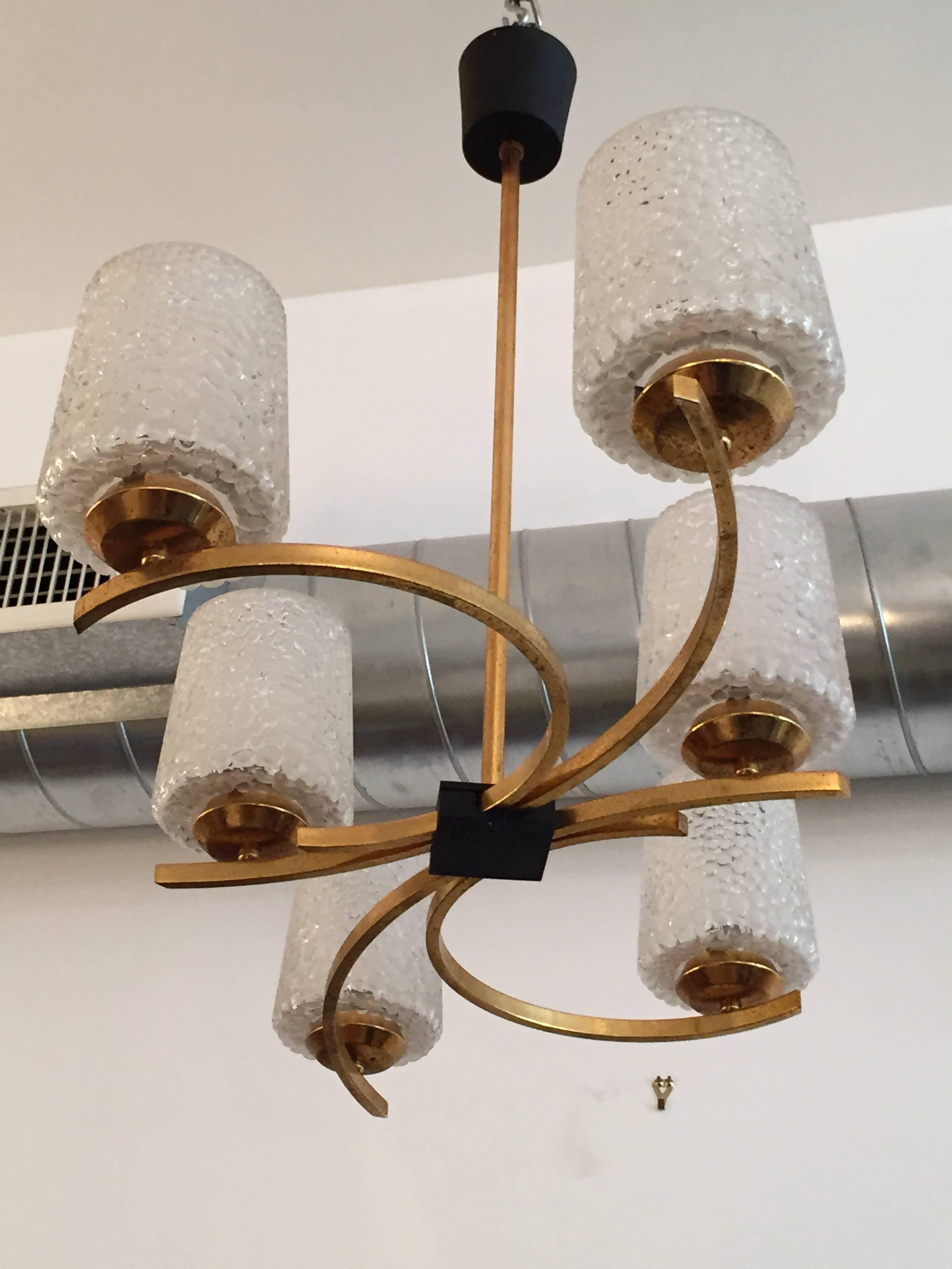 A wonderful pair of original 1960s French pendant chandeliers composed of lightly gilded brass serpentine bodies with bubbled lightly frosted handblown glass shades. Newly rewired.