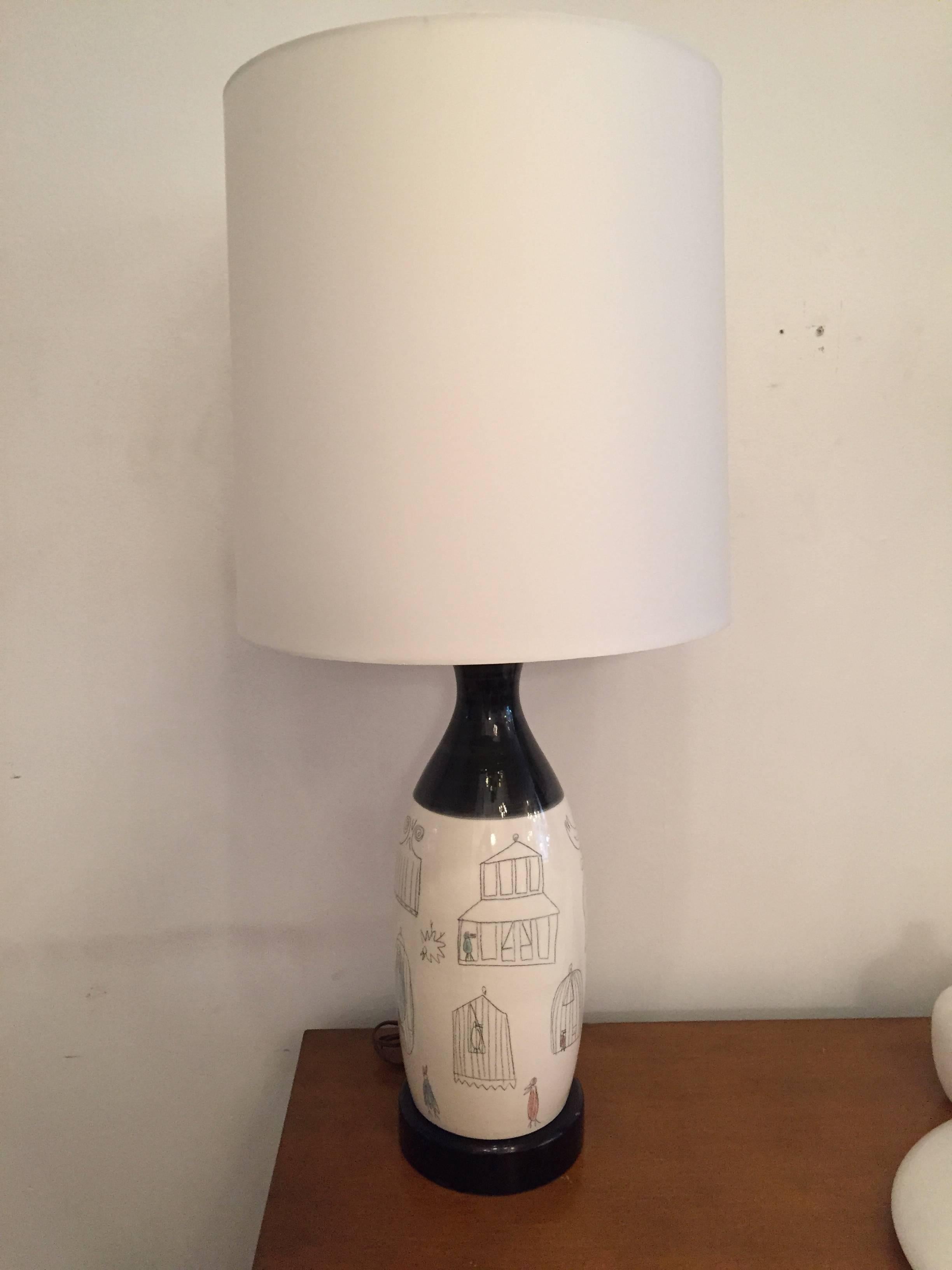 A pair of 1960s white and black hand-painted French art pottery table lamps. Newly wired.