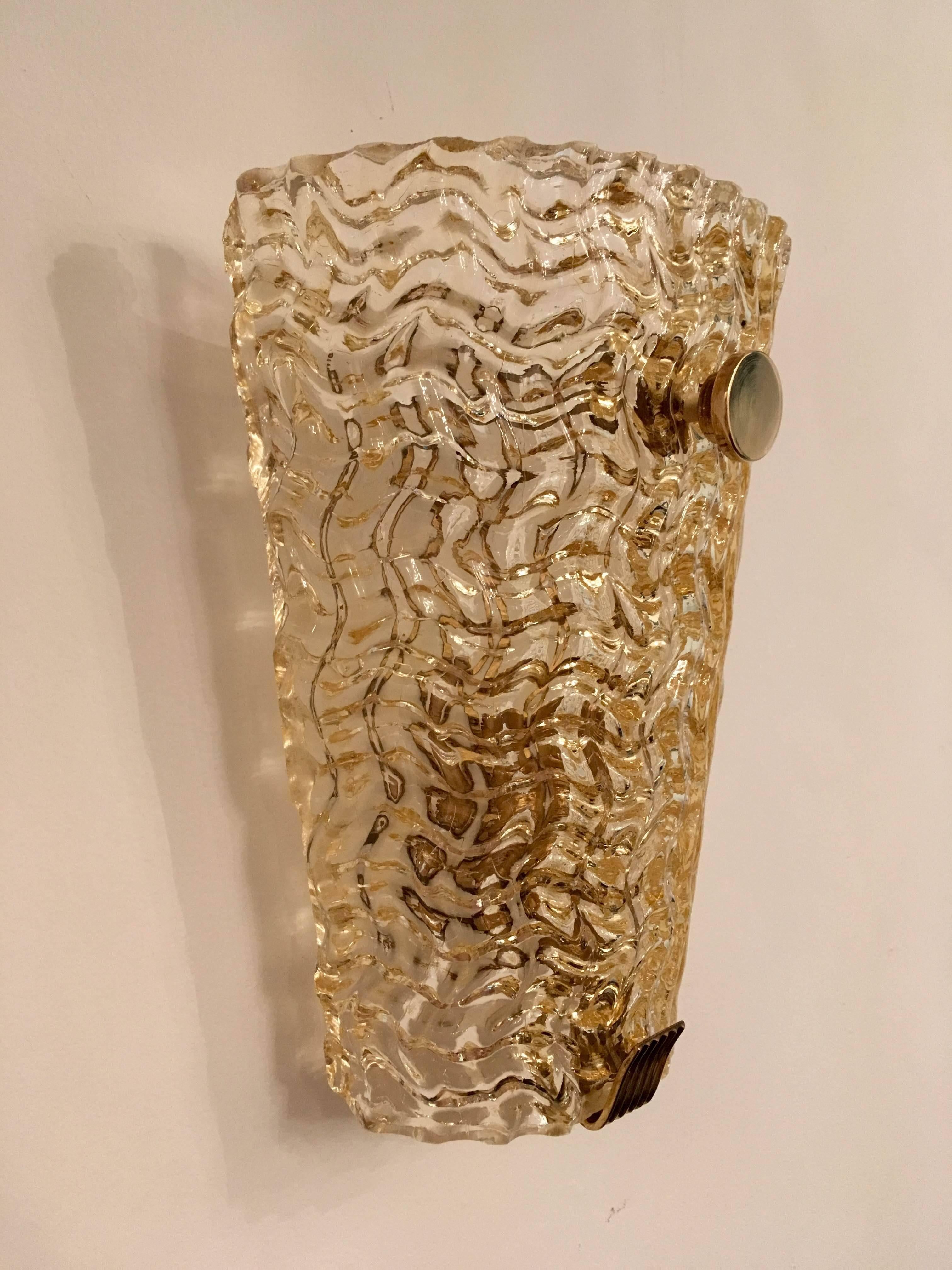 A great pair of 1980s Swedish blown glass sconces with gold layered into the textured waved glass. They each take 100 watt bulbs and the have polished brass holders. Newly rewired.