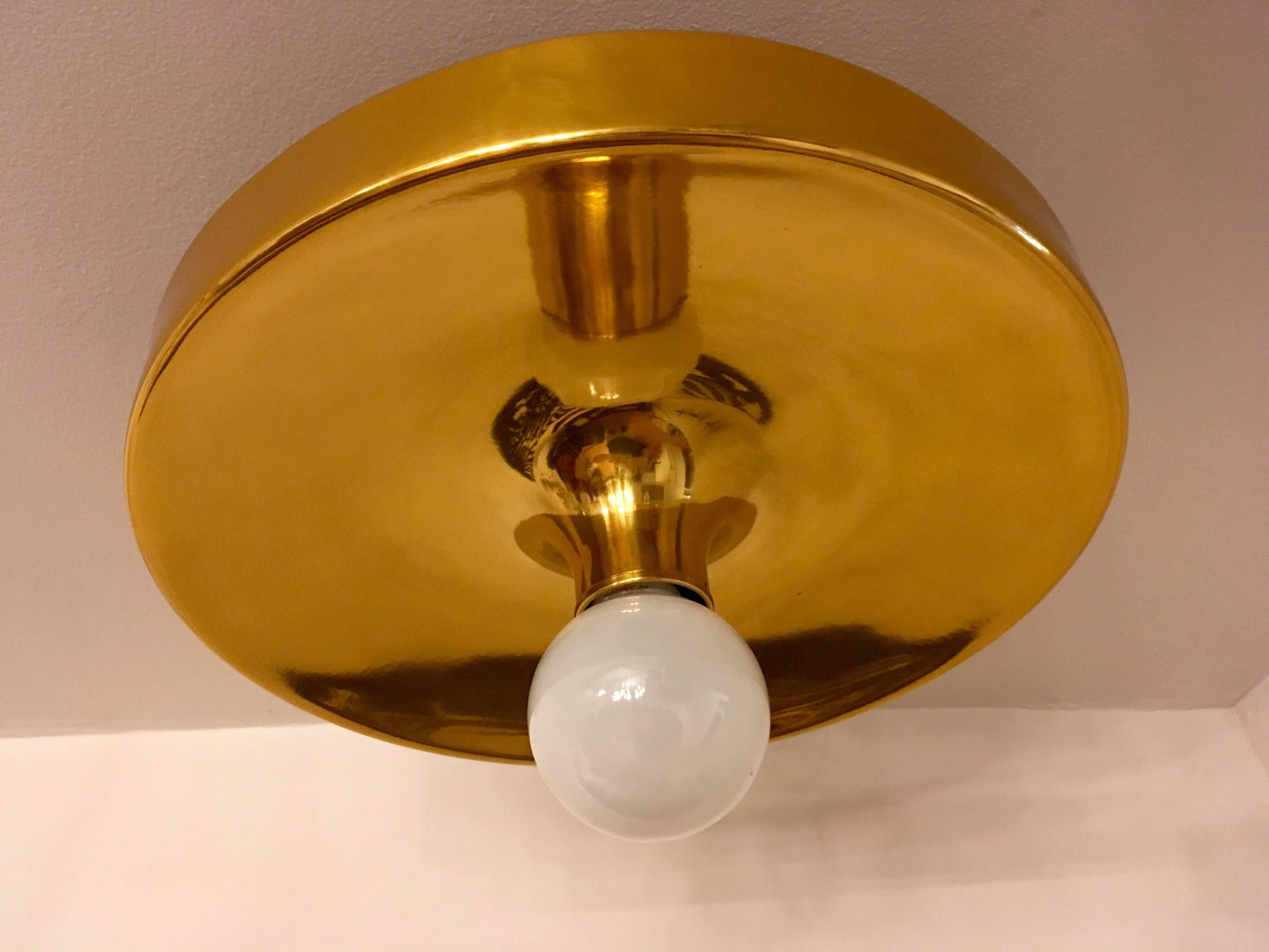 An original set of 1960s space age flush ceiling lights made by Honsel in polished gold mirror enamel. Charlotte Perriand used this lamp in apartments at the Les Arcs ski resort. Newly rewired.