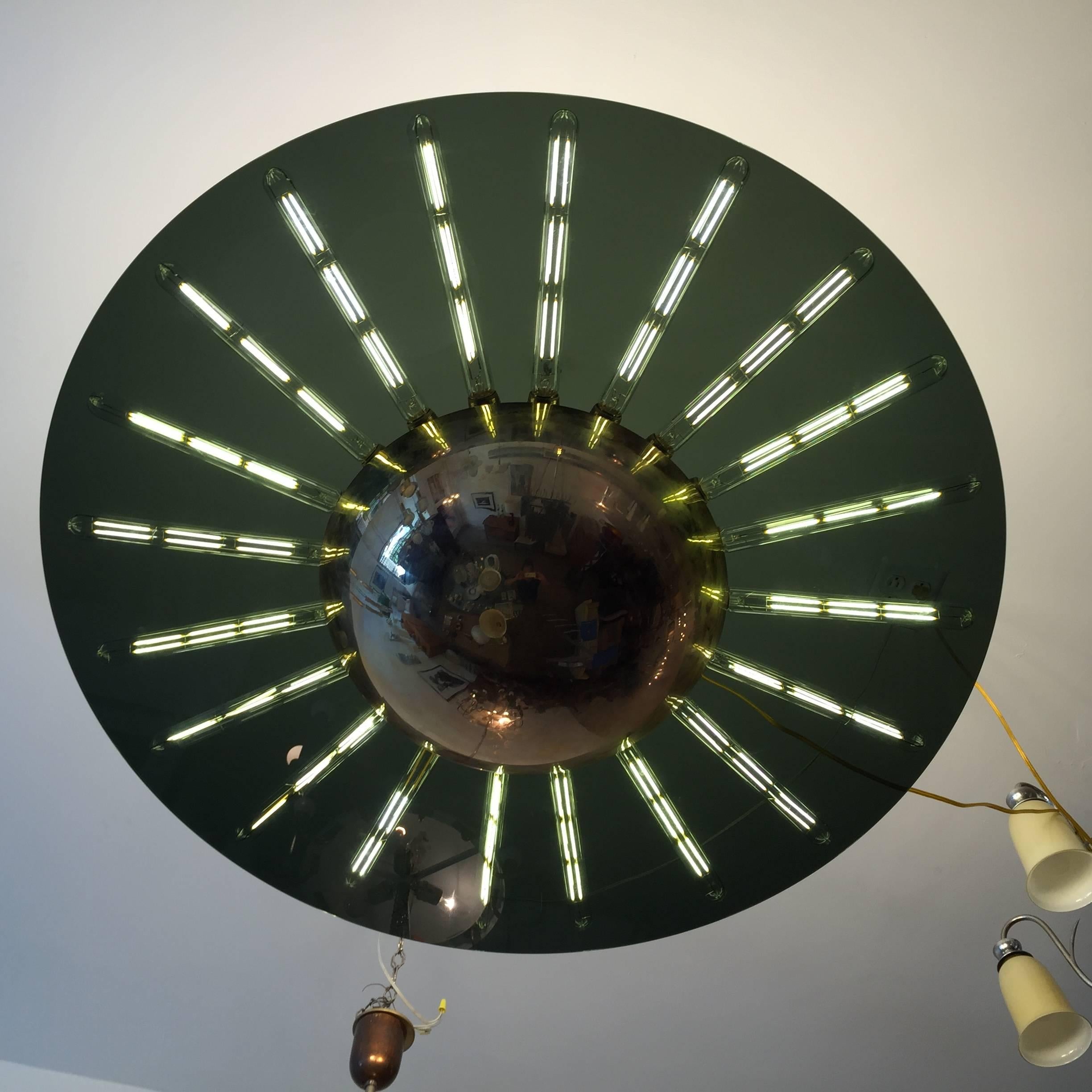 A wonderful large 40" flush ceiling light composed of a round smoked glass plate and a polished brass half sphere. 20 light sources. Small ceiling pole attached to a round flat polished brass canopy. Artist signed and numbered “MT Wilson # 3”.