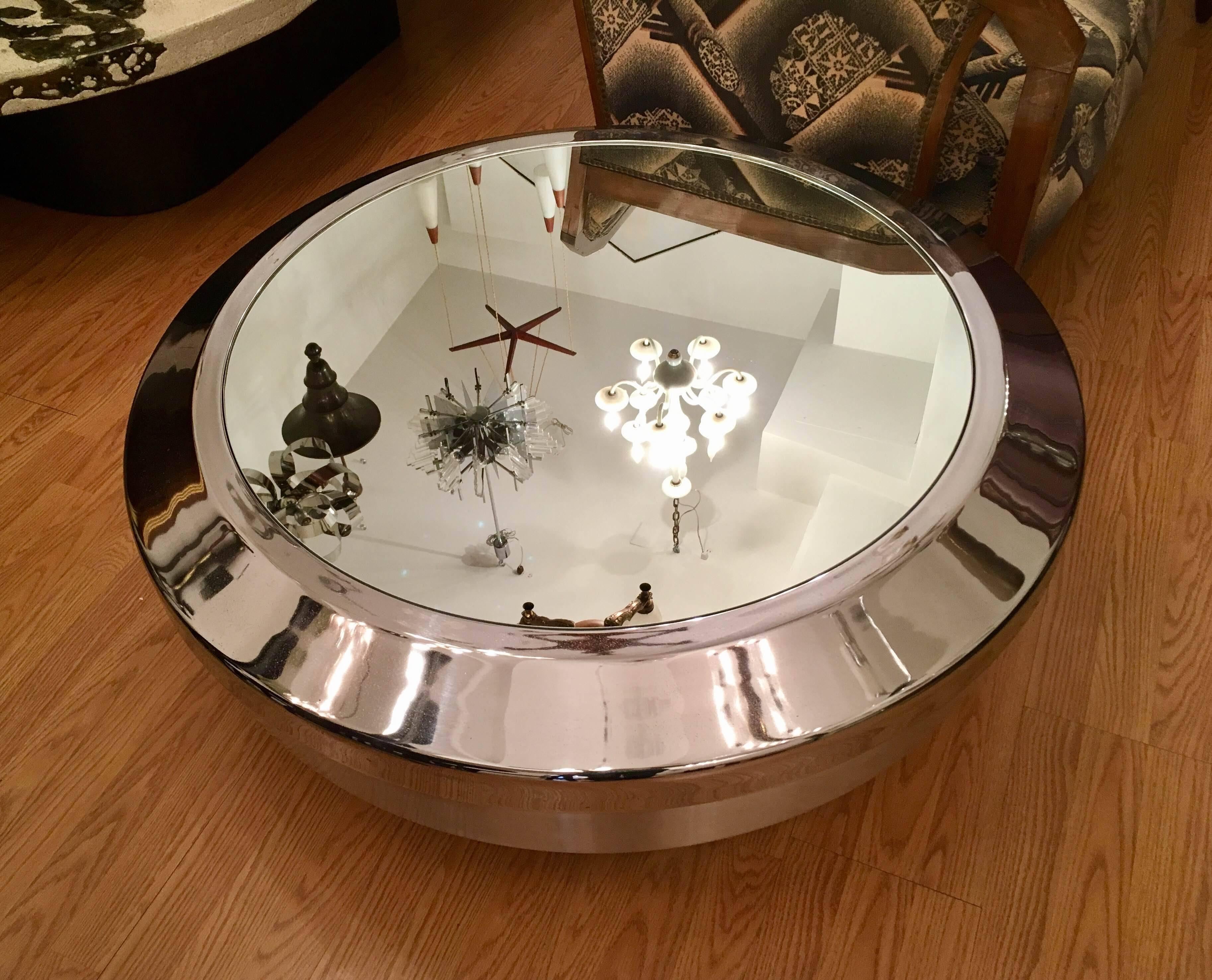 A rare pair of Space Age design coffee tables by Venice, California-based architect, Gary John Neville. The cocktail tables are composed of a brushed spun metal base and a polished chrome and a mirror top.