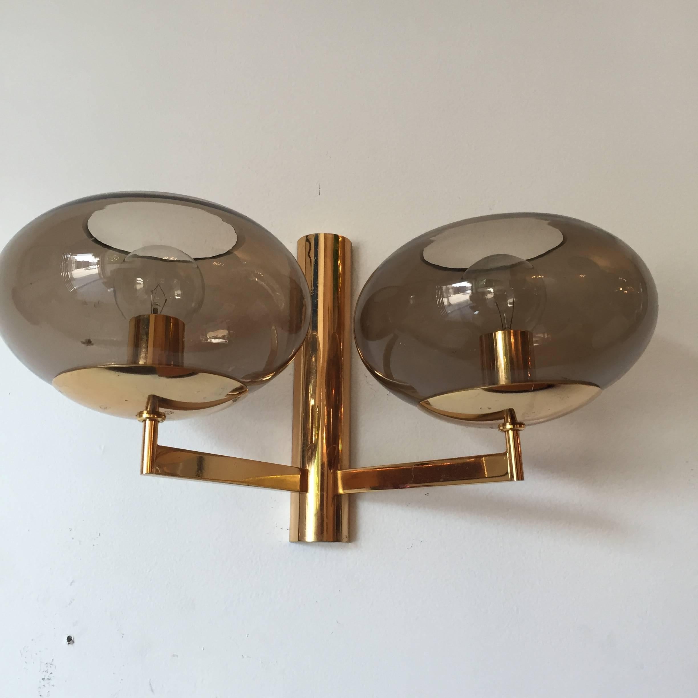 An original set of 1960s Italian polished brass and smoked glass globes wall lights by Sciolari. Rewired.