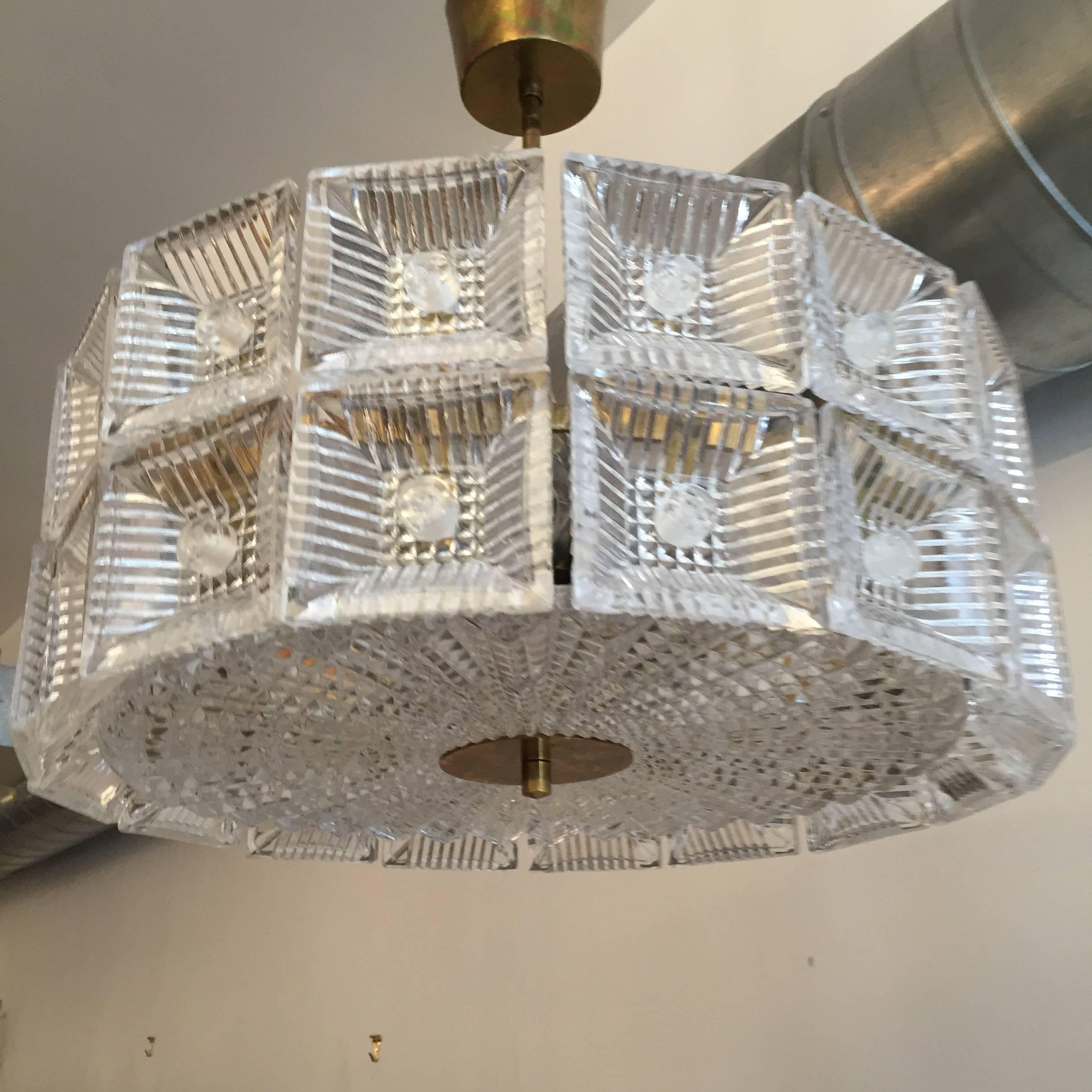 A wonderful original 1960s Swedish crystal hanging pendant or flush ceiling light designed by Carl Fagerlund for Orrefors. The light is composed of two rows of thick cut crystal square elements and one large circular crystal diffuser and polished