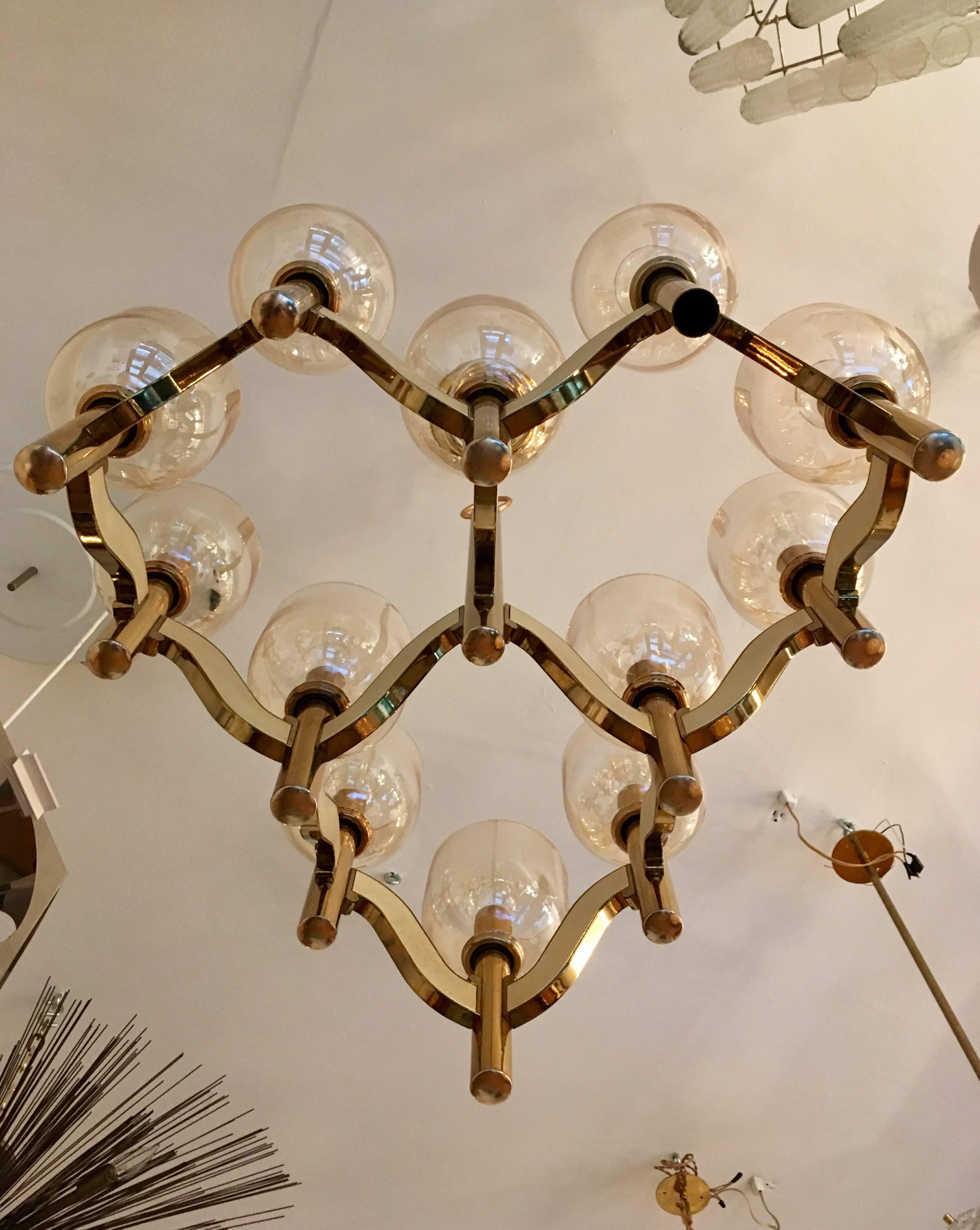 A beautiful 1970s polished brass pendant with light golden glass shades. Newly rewired.