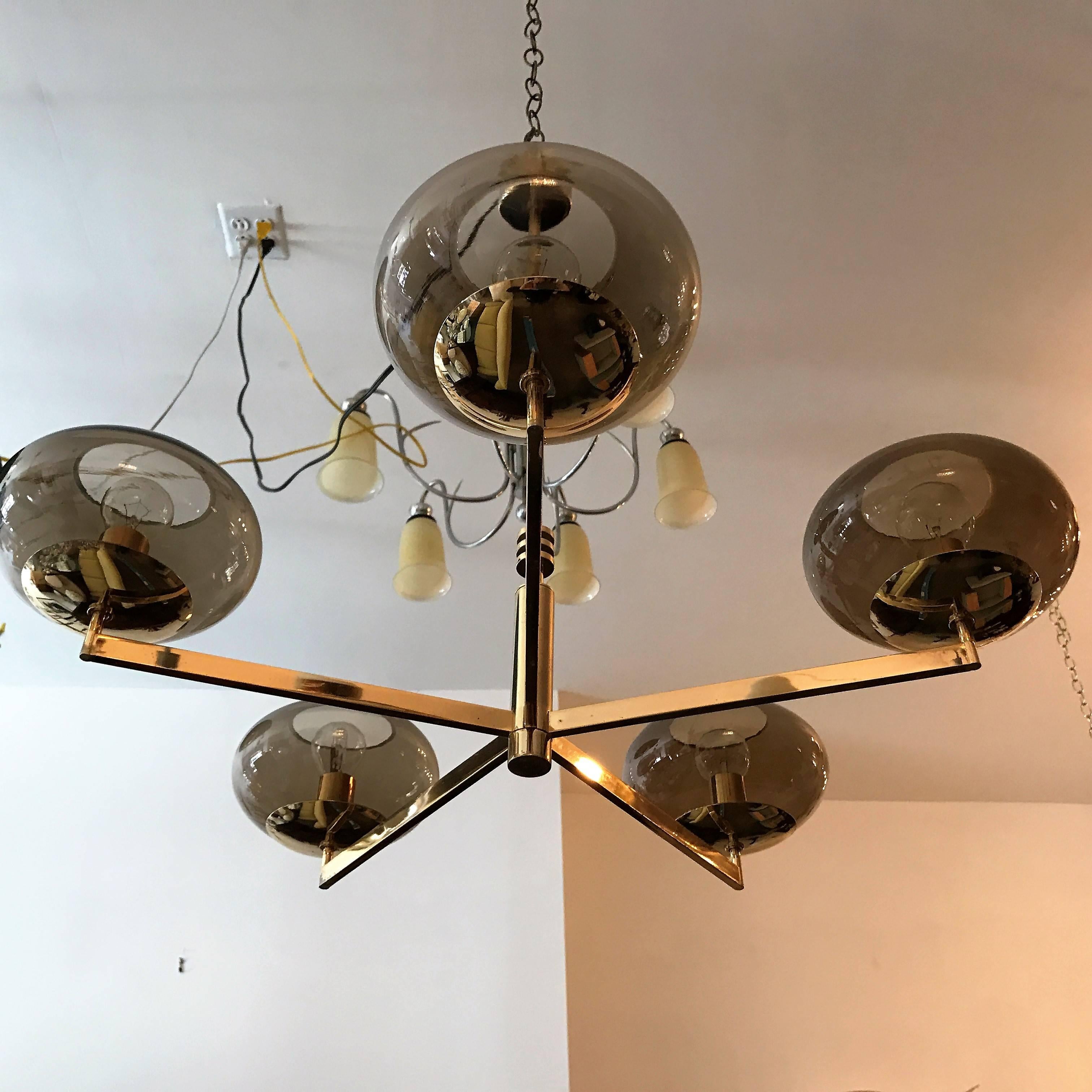 A great sleek 1970s modern five-light pendant composed of a polished brass frame and smoked glass globe shades by the famed Italian lighting company, Sciolari . Rewired. Matching one arm and sconces. Matching three-light pendant also available.