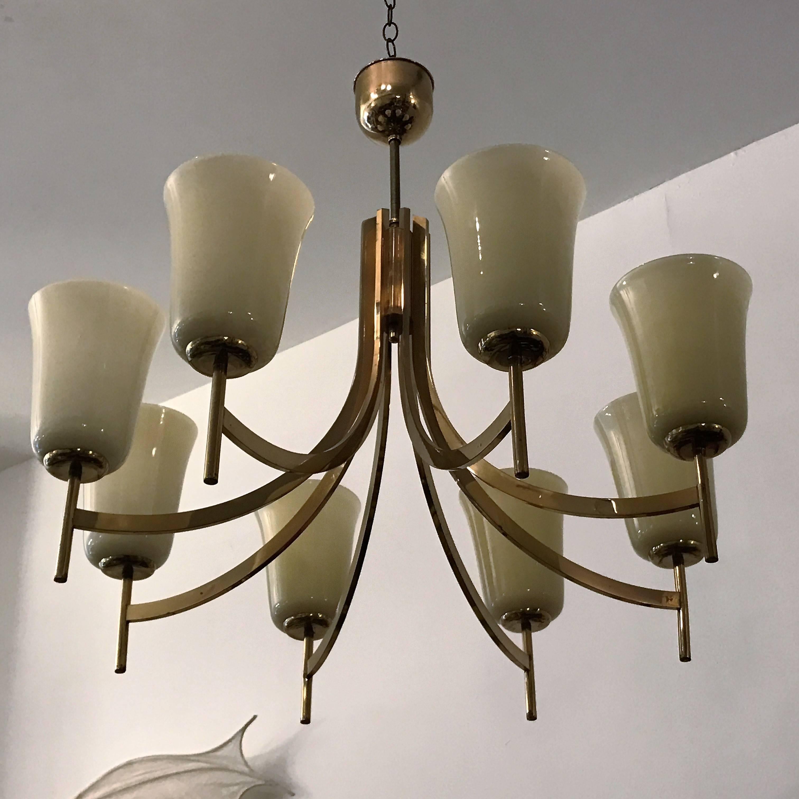 An original 1950s Swedish chandelier composed of an aged polished brass swooping frame and large custard glass shades. Newly rewired.