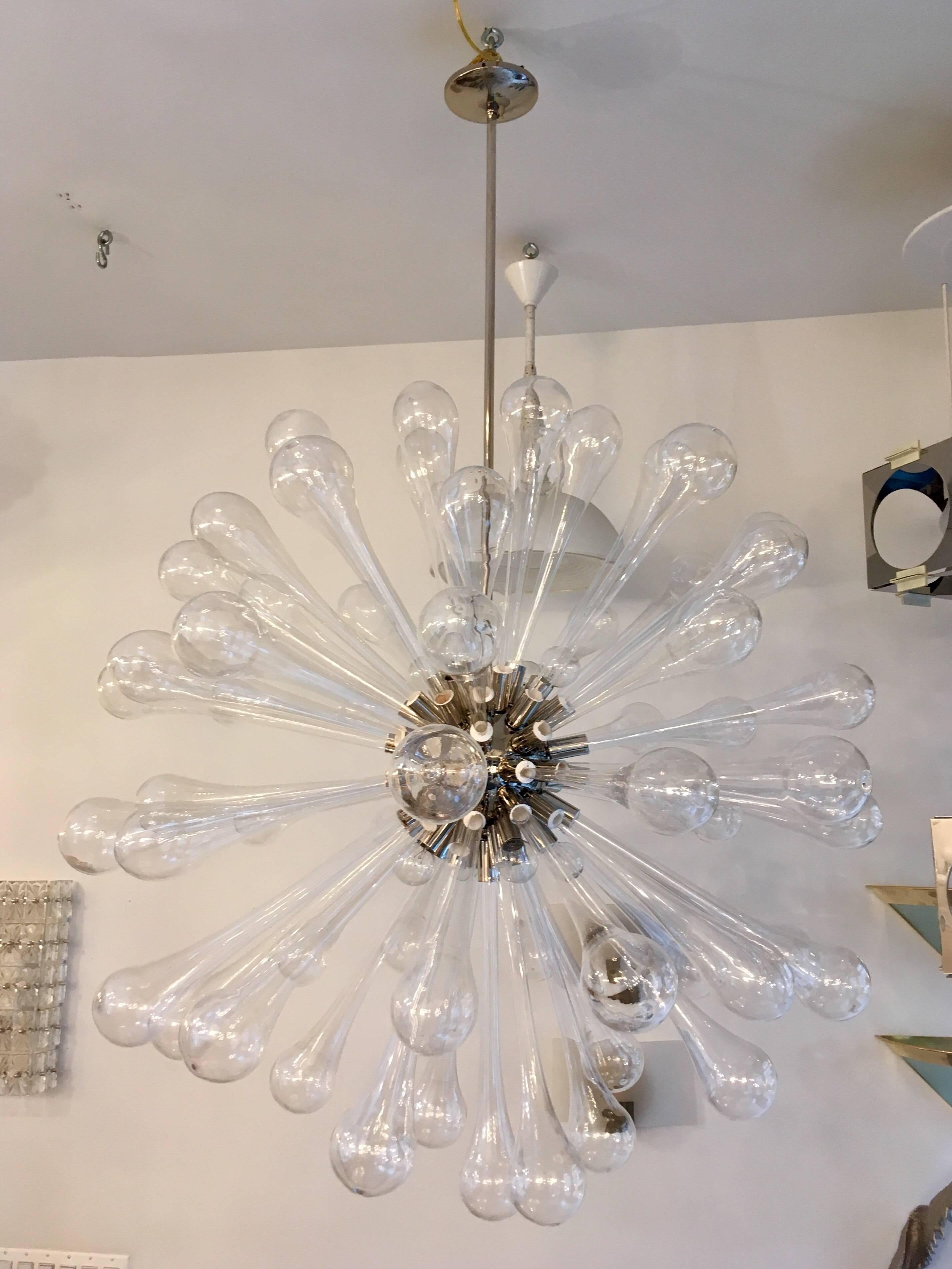 A handblown Murano glass 1960s, Italian chandelier. The chandelier is composed of a polished chrome fixture with very large handblown glass tear drop shaped elements. Rewire . Excellent condition.