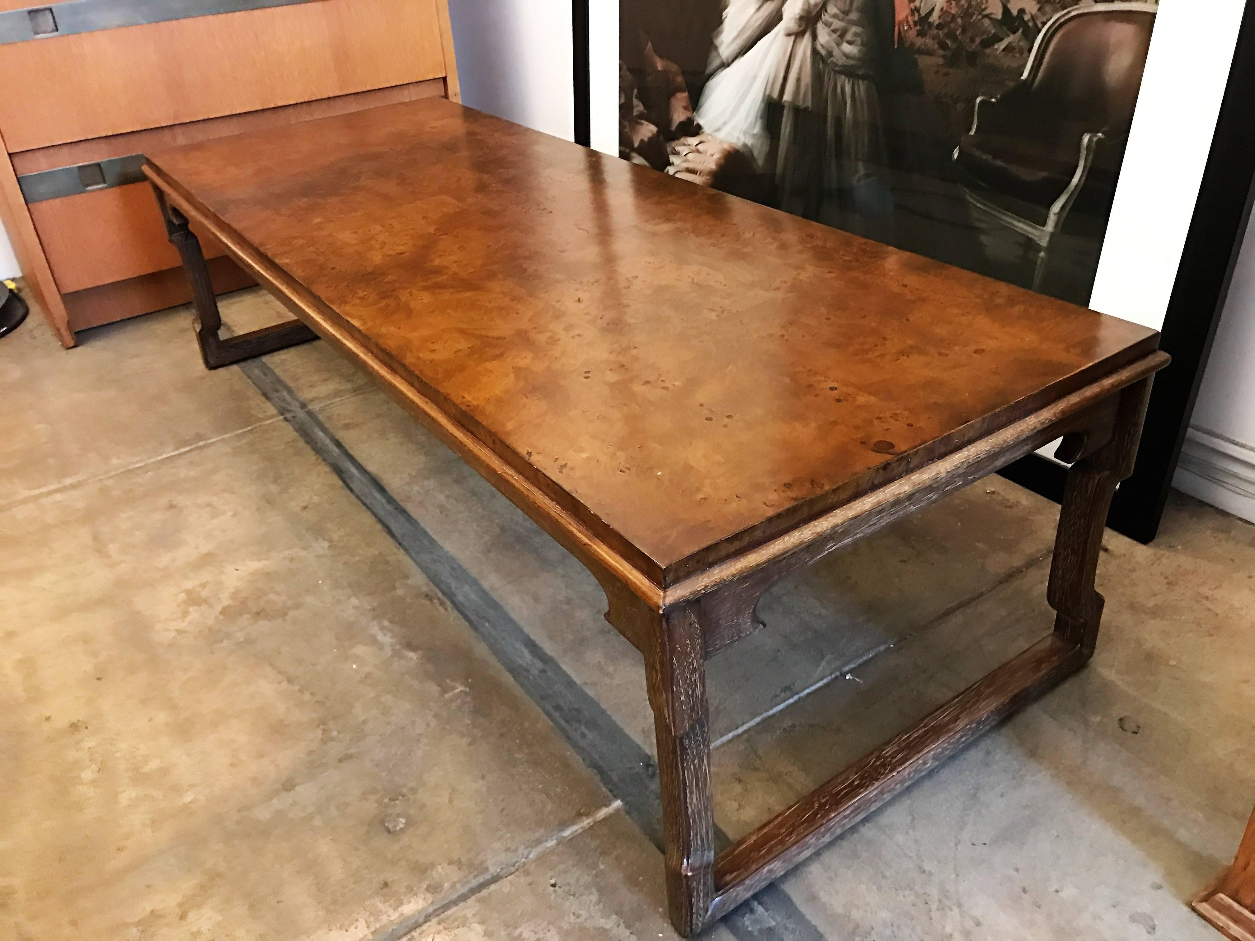 A wonderful 1960s cocktail table with a cerused limed wood base and a polished burl match-booked walnut top. Original label.