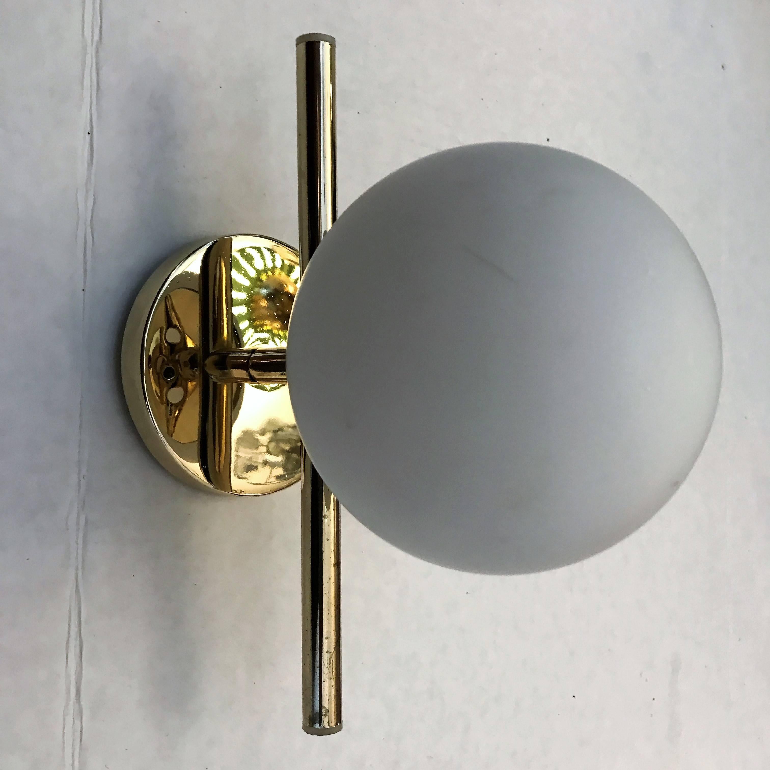 A great set of three sleek modern 1950s polished brass wall lights with frosted glass globes shades. Newly rewired.