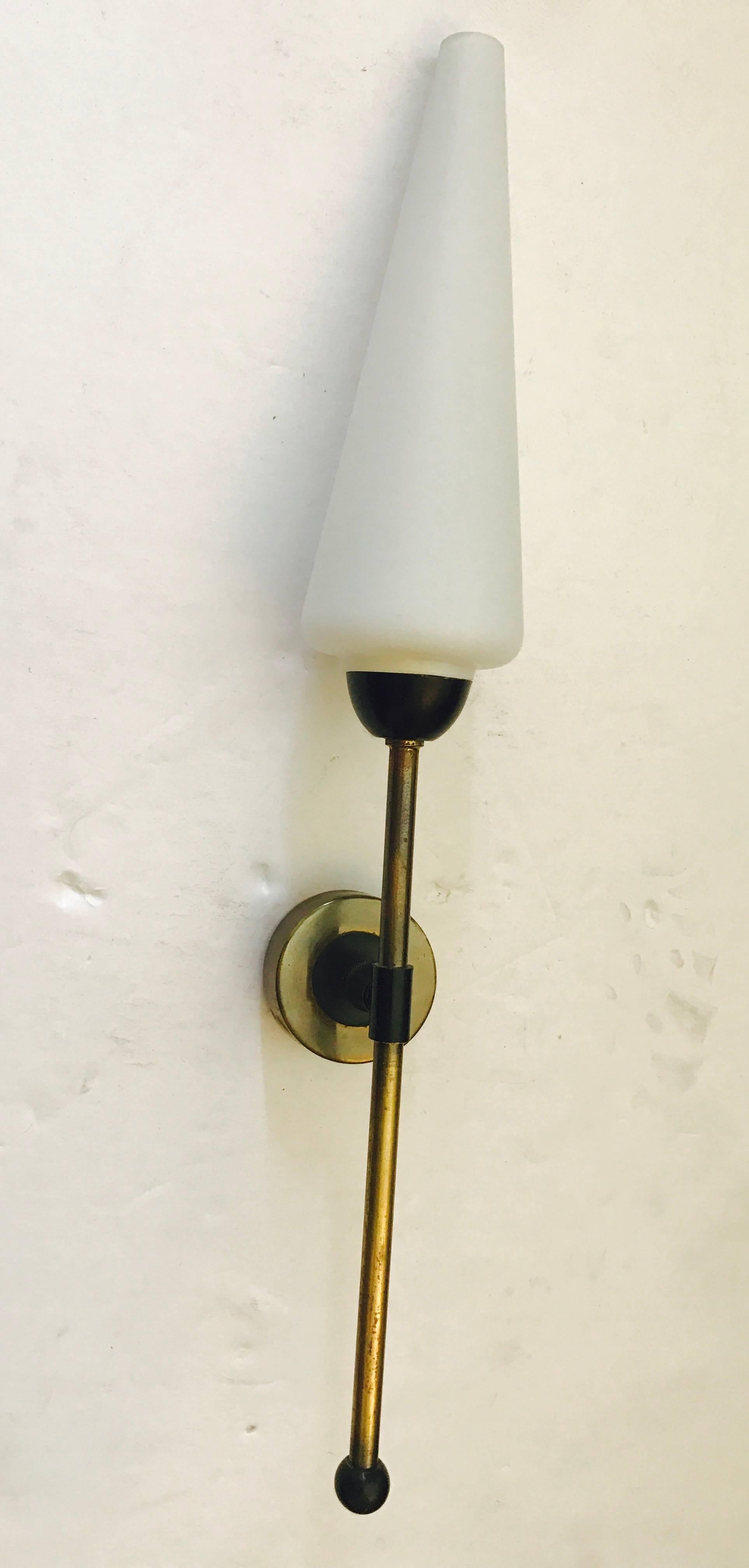 An original pair of 1950s French aged brass and black enamel wall lights with white glass cone shades. Newly rewired.