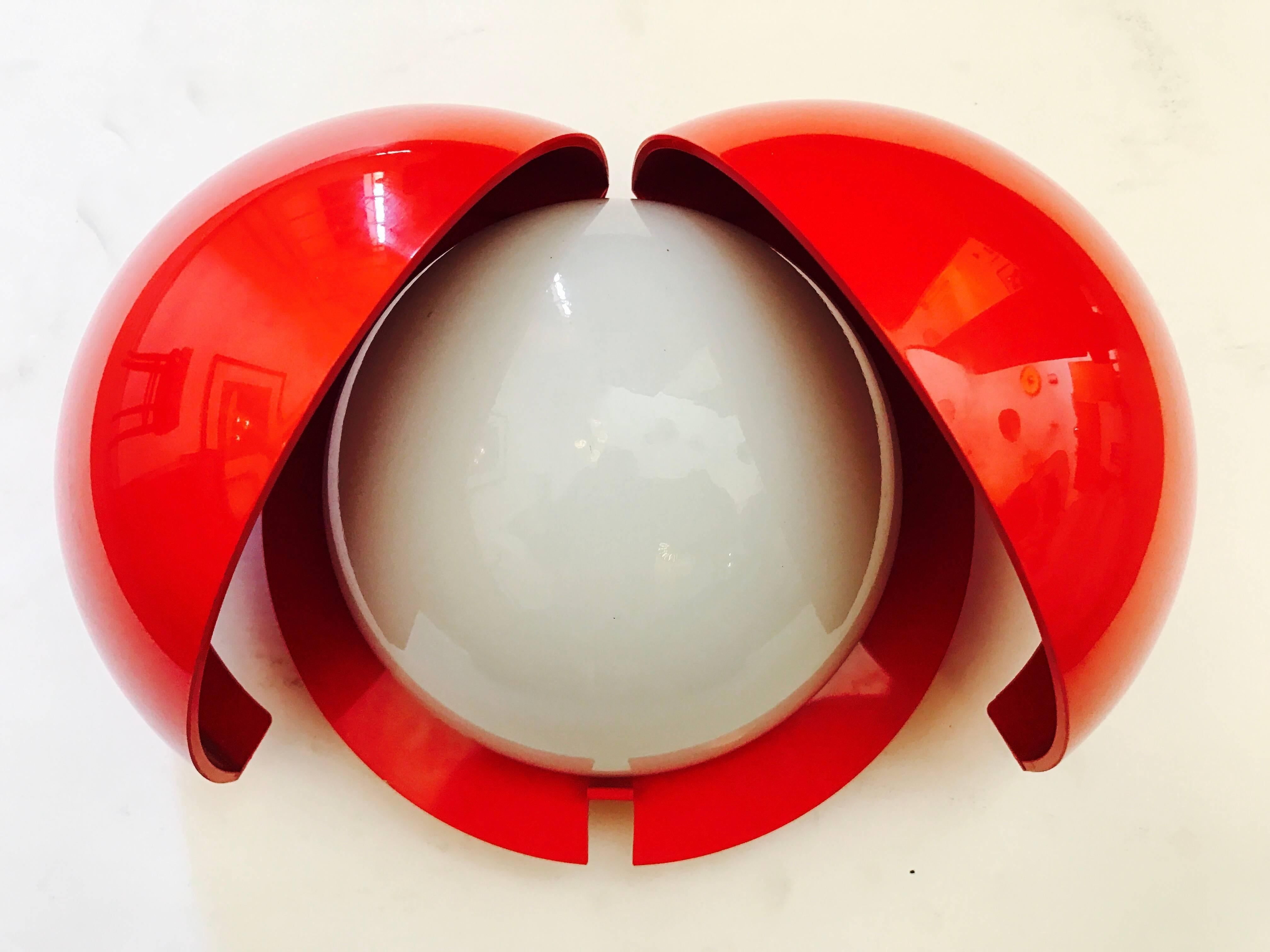 An original 1970s space age wall or table light composed of an ABS cover and white opaline glass shade designed by Gianemilio, Piero and Anna Monti for Fontana Arte. Newly rewired. The brightness level can be adjusted by the opening and closing of