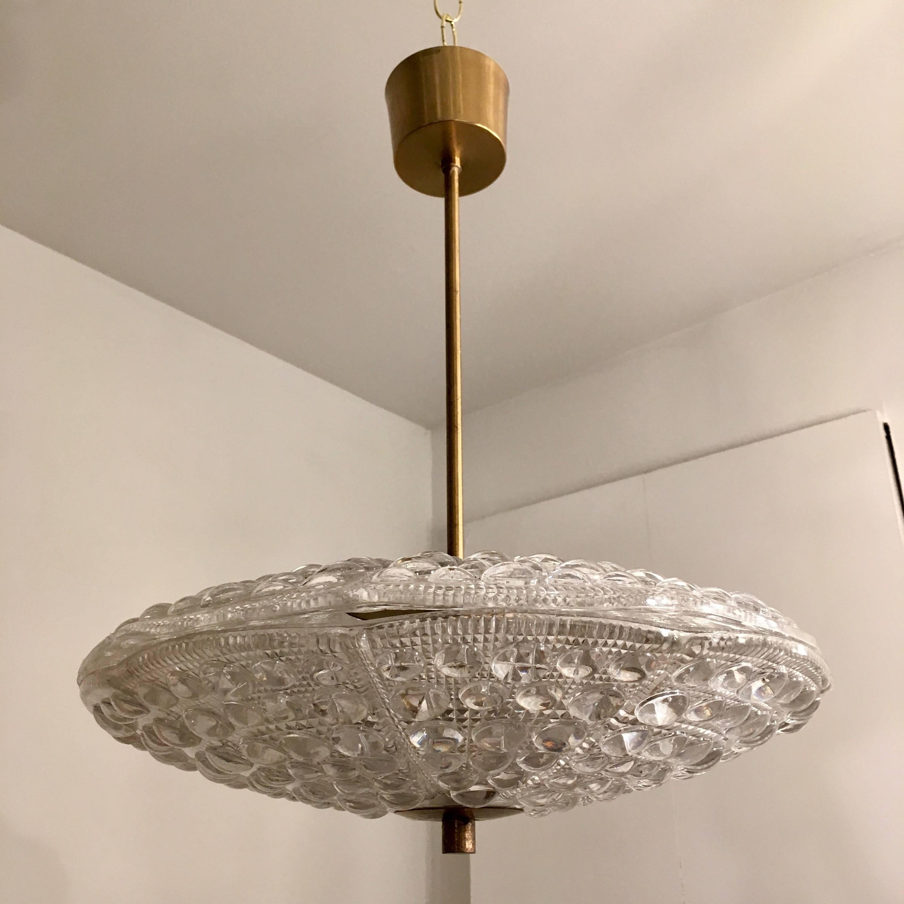 A pair ofSwedish 1950s thick textured two-piece Crystal pendants  designed by Carl Fagerlund for Orrefors with aged brass fittings.