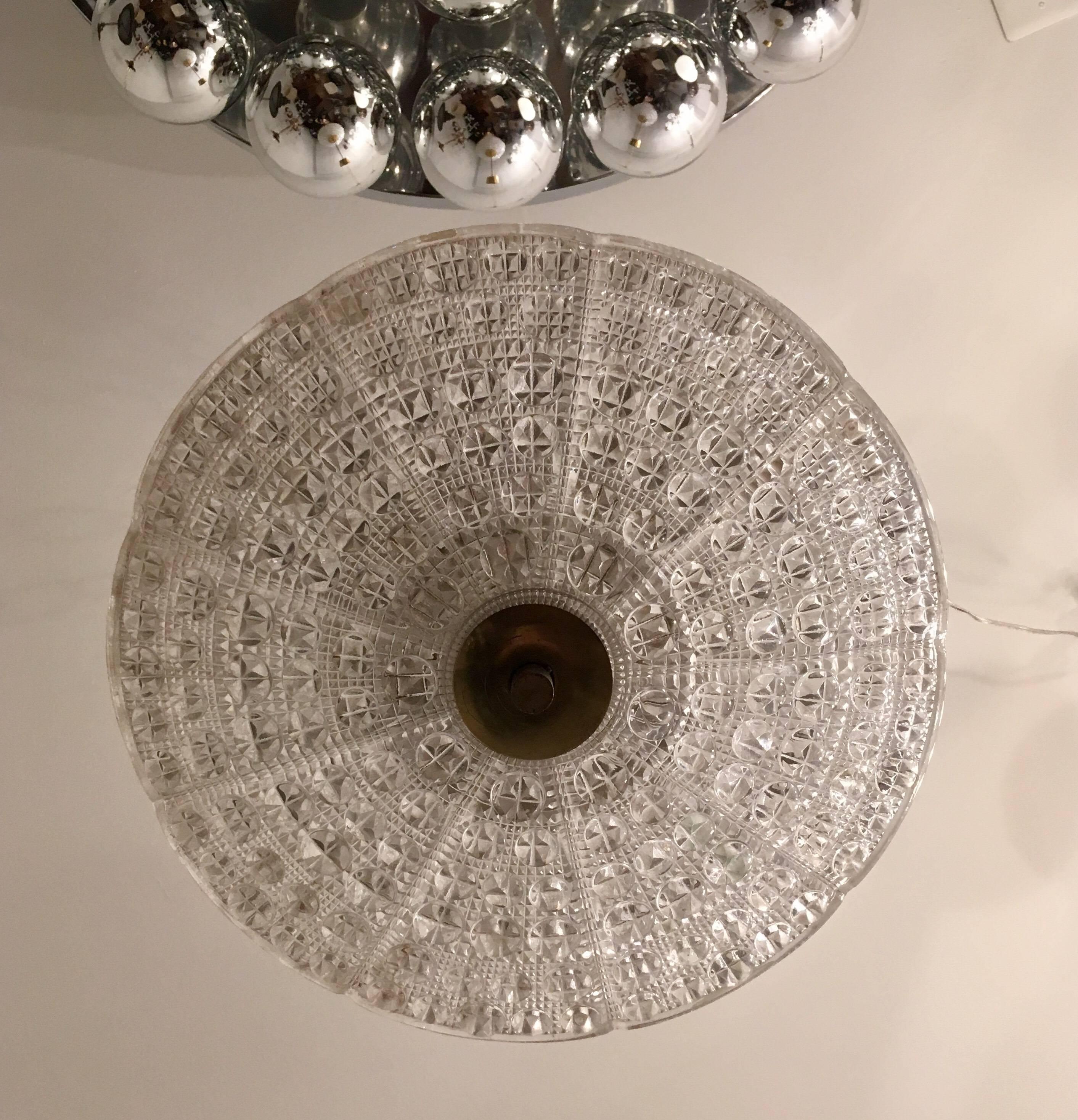 A Swedish 1950s thick bubbled textured two-piece glass and polished brass pendant designed by Carl Fagerlund for Orrefors. Newly Rewired. Five candelabra sockets. Newly Rewired.
