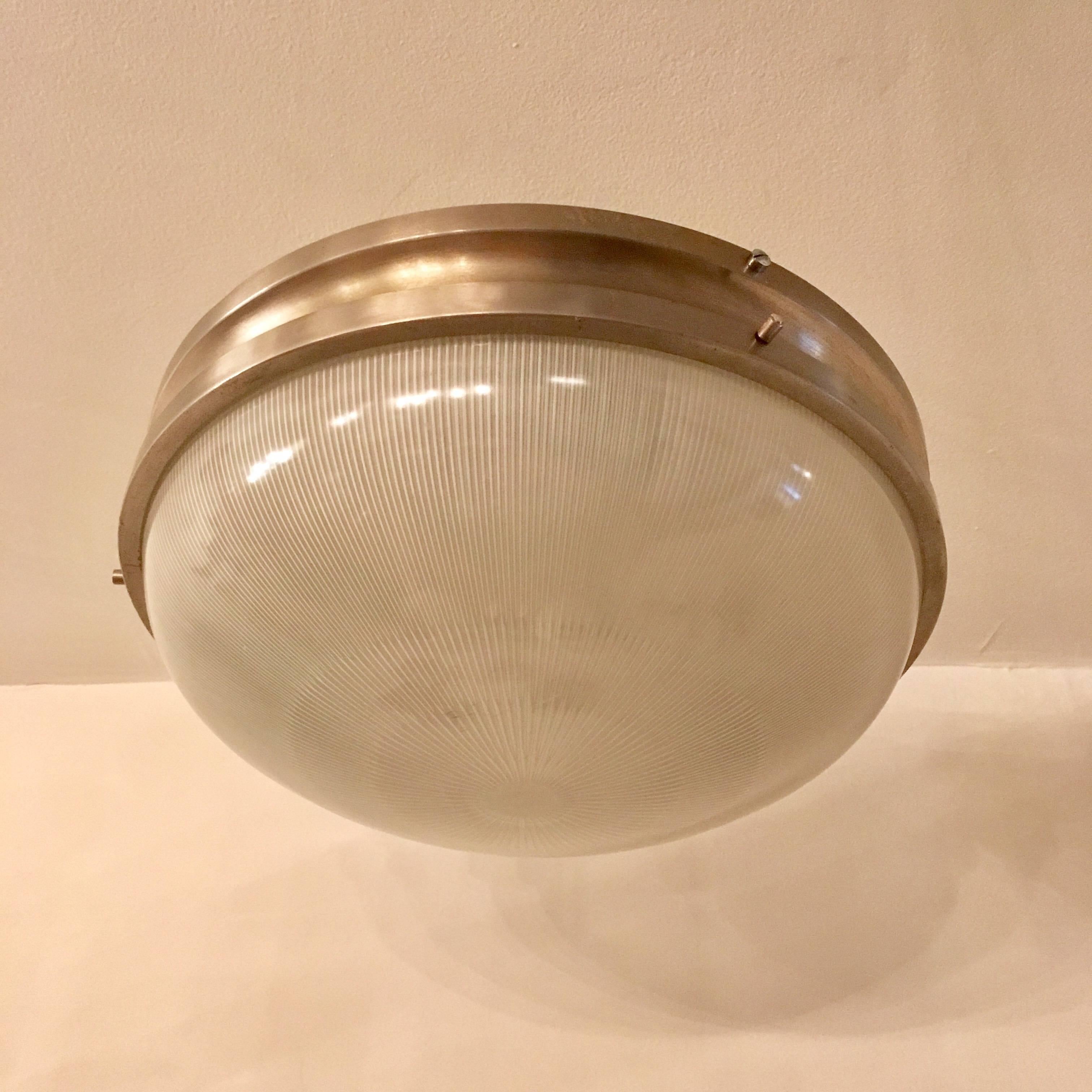 An original 1960s, Italian Mid-Century flush ceiling light or wall sconce designed by Sergio Mazza for Artemide. A Holophane glass shade and an Industrial matte silver fixture. Newly rewired.