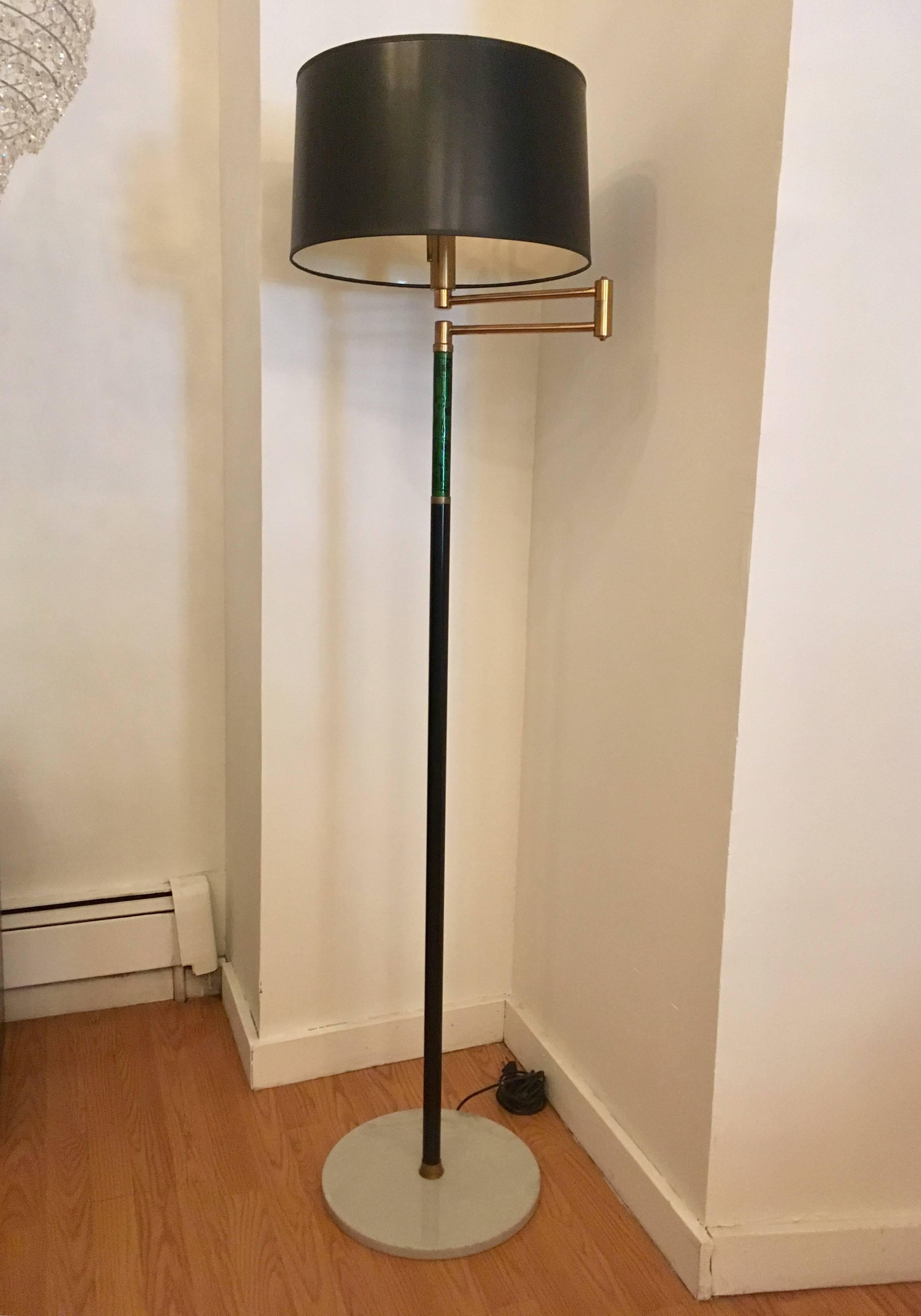 An original Mid-Century Italian floor lamp with a brass swing arm and decorative colored enamel to the neck and a Carrara marble base. Newly Rewired.