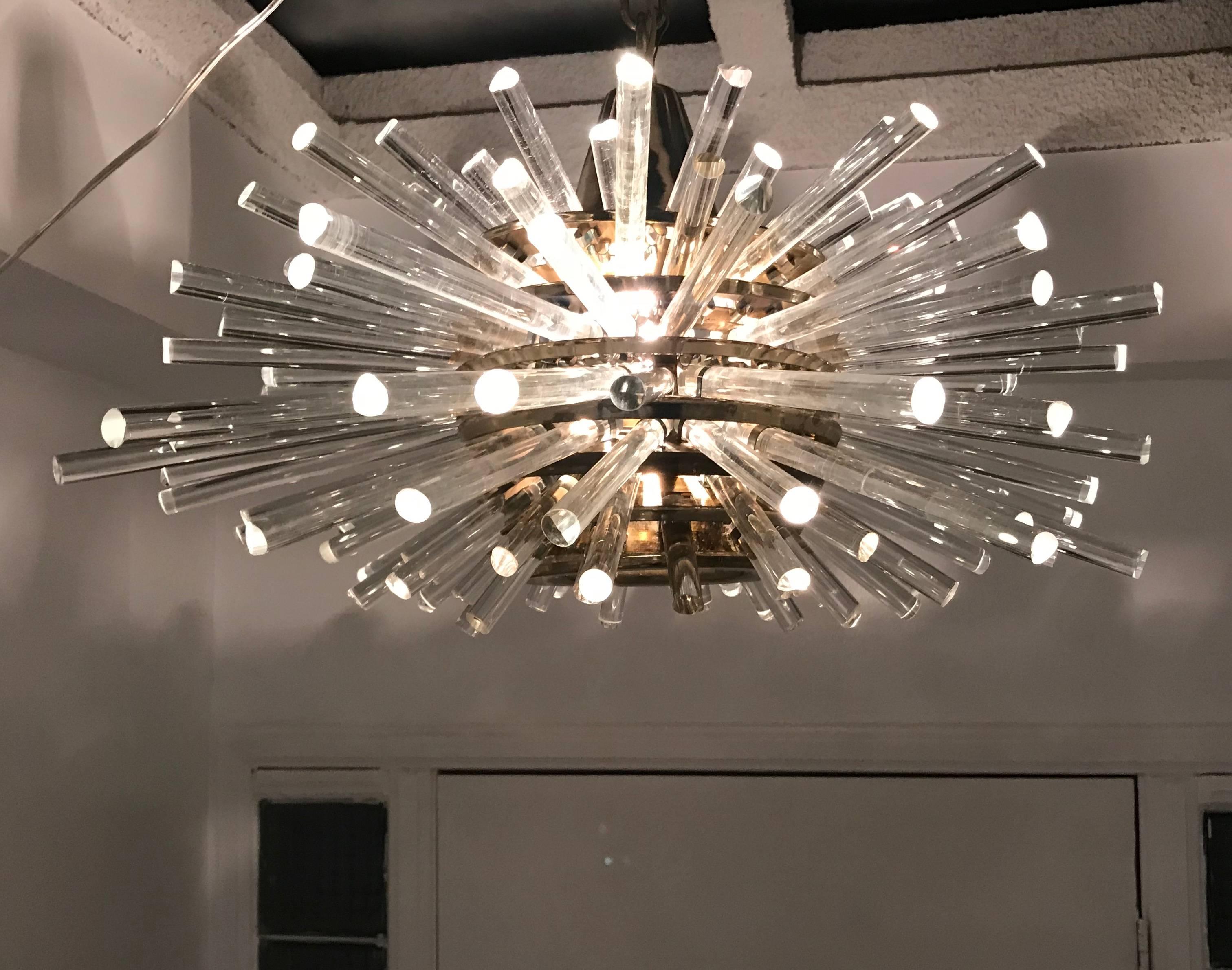 An original iconic 1960s design by the Austrian Crystal company, Bakalowits and Sohn. The Miracle chandelier is composed of a polished brass frame with seven tiers of different length crystals. Newly Rewired with a porcelain standard 360 watt