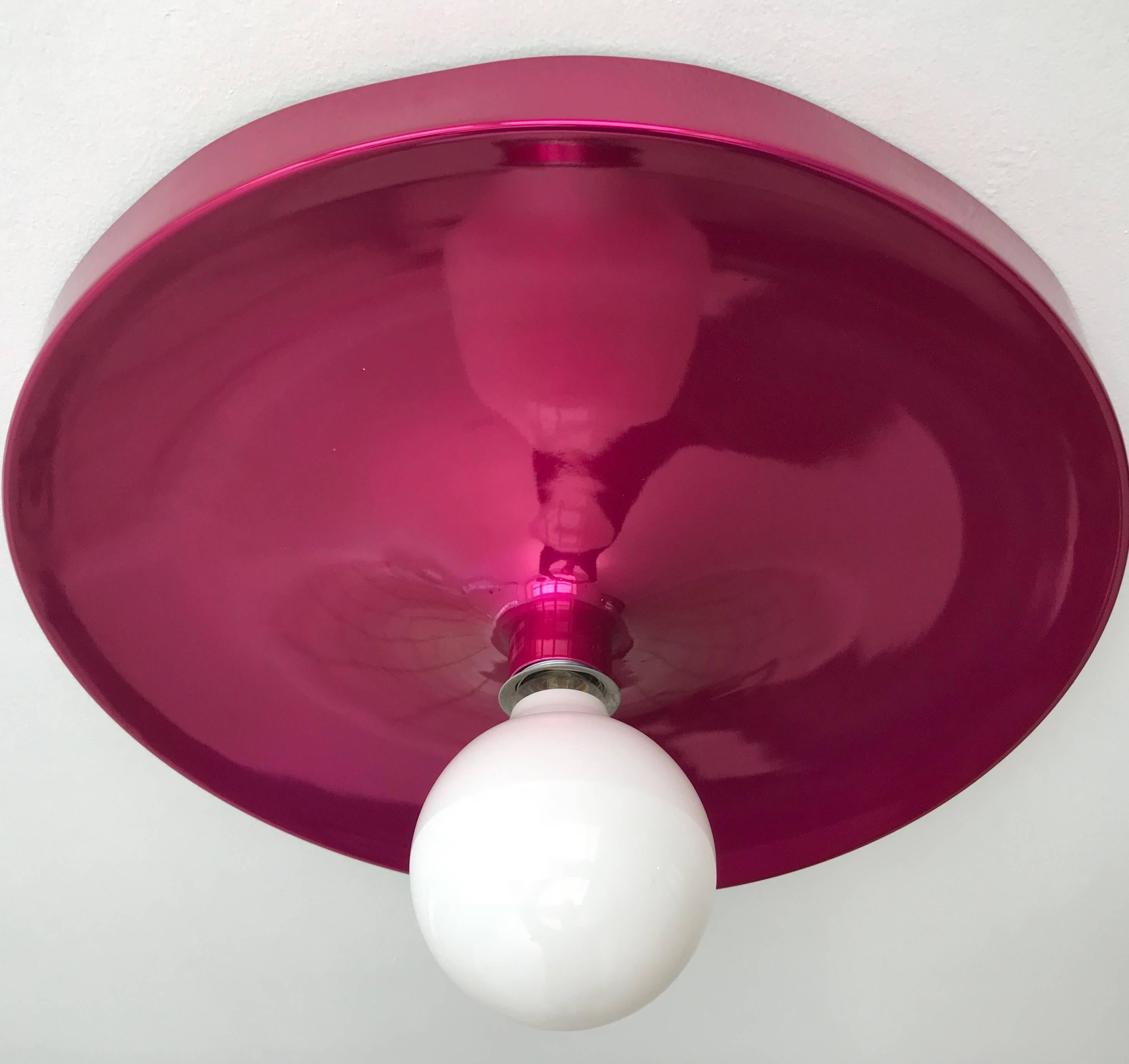 A sleek modern 1970s Space Age German flush ceiling light. The beautiful enamel is razzberry/ Fushia color ina reflective candy coat. Rewired with grounding wire. Charlotte Periand used this lamp in his commission, Les Arcs Ski Resort.