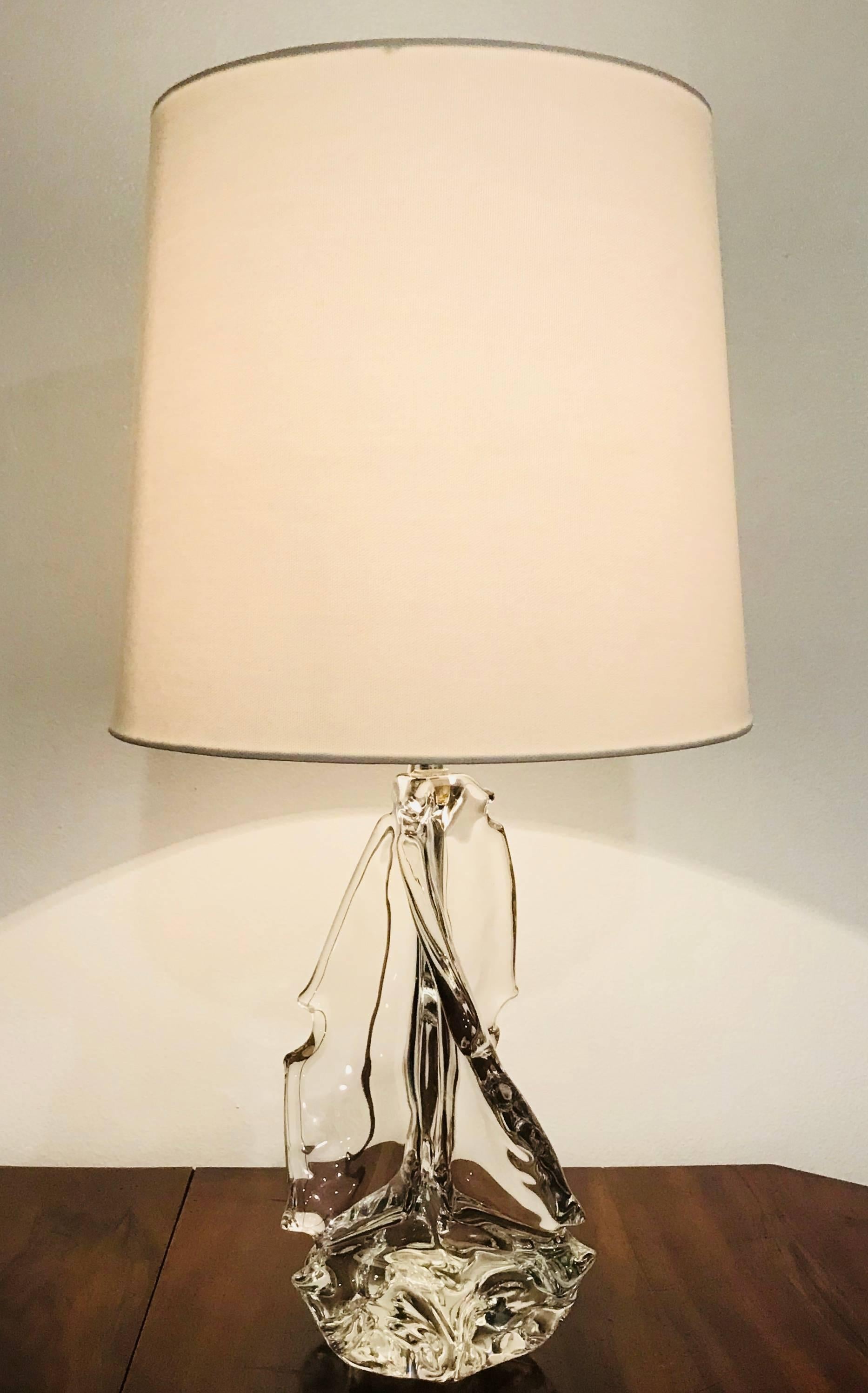 A luxurious pair of sculptural solid clear crystal table lamp by the French maker, Schneider. Signed. Newly rewired. 25” height with 12” shade shown.