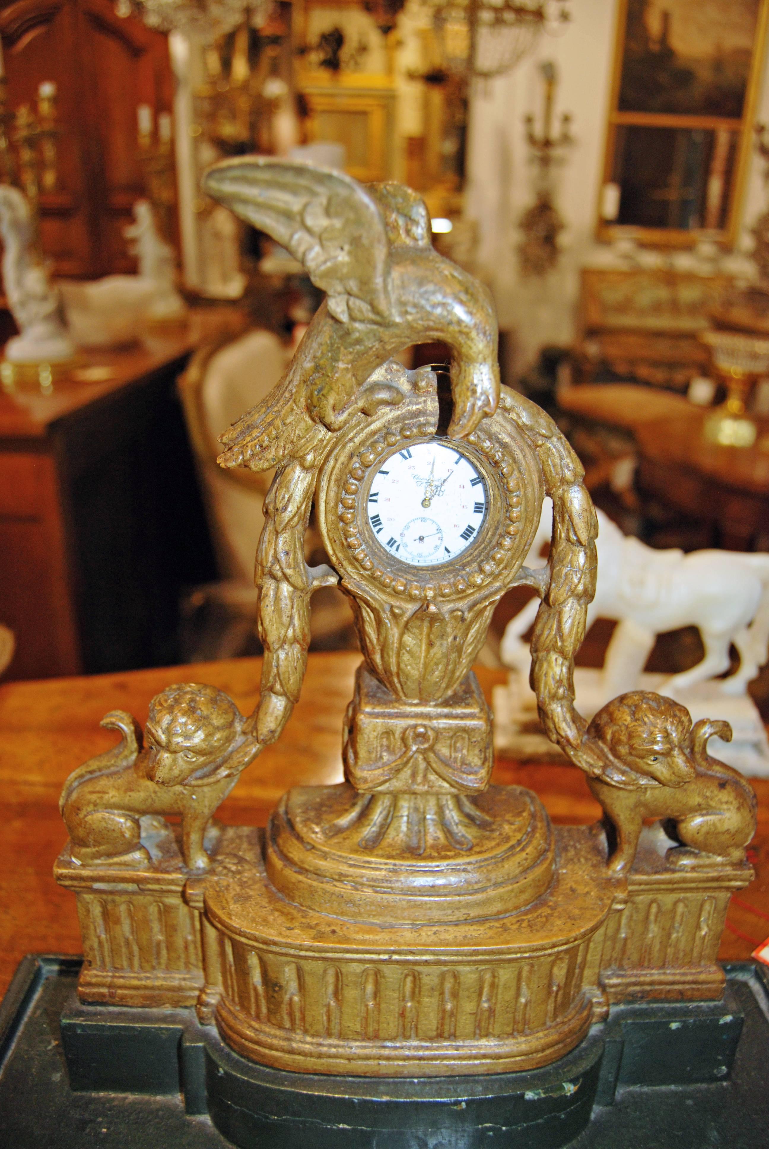 Beautifully carved figural giltwood pocket watch stand.