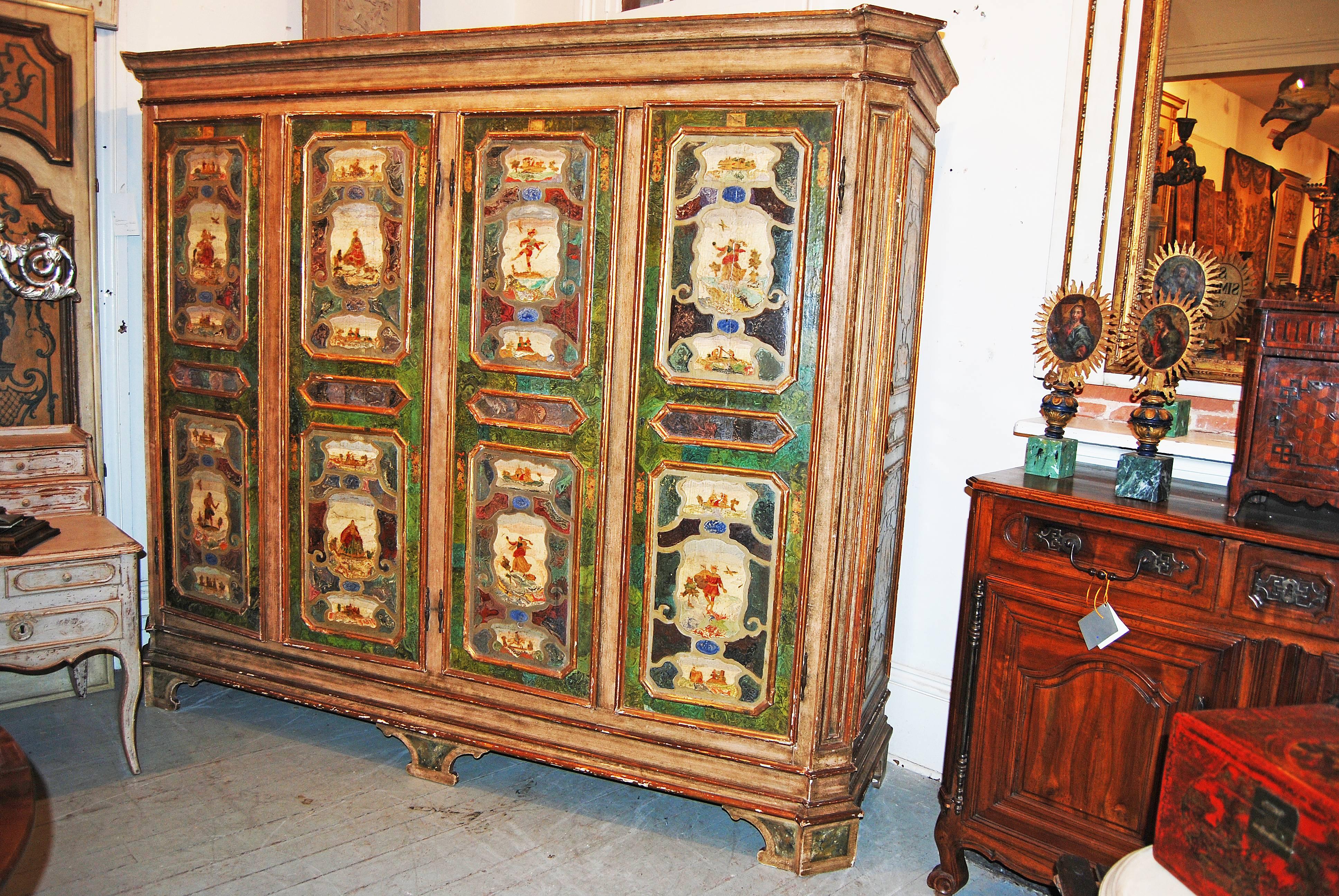 Beautiful Italian armoire made up of exceptional carved and painted panels.