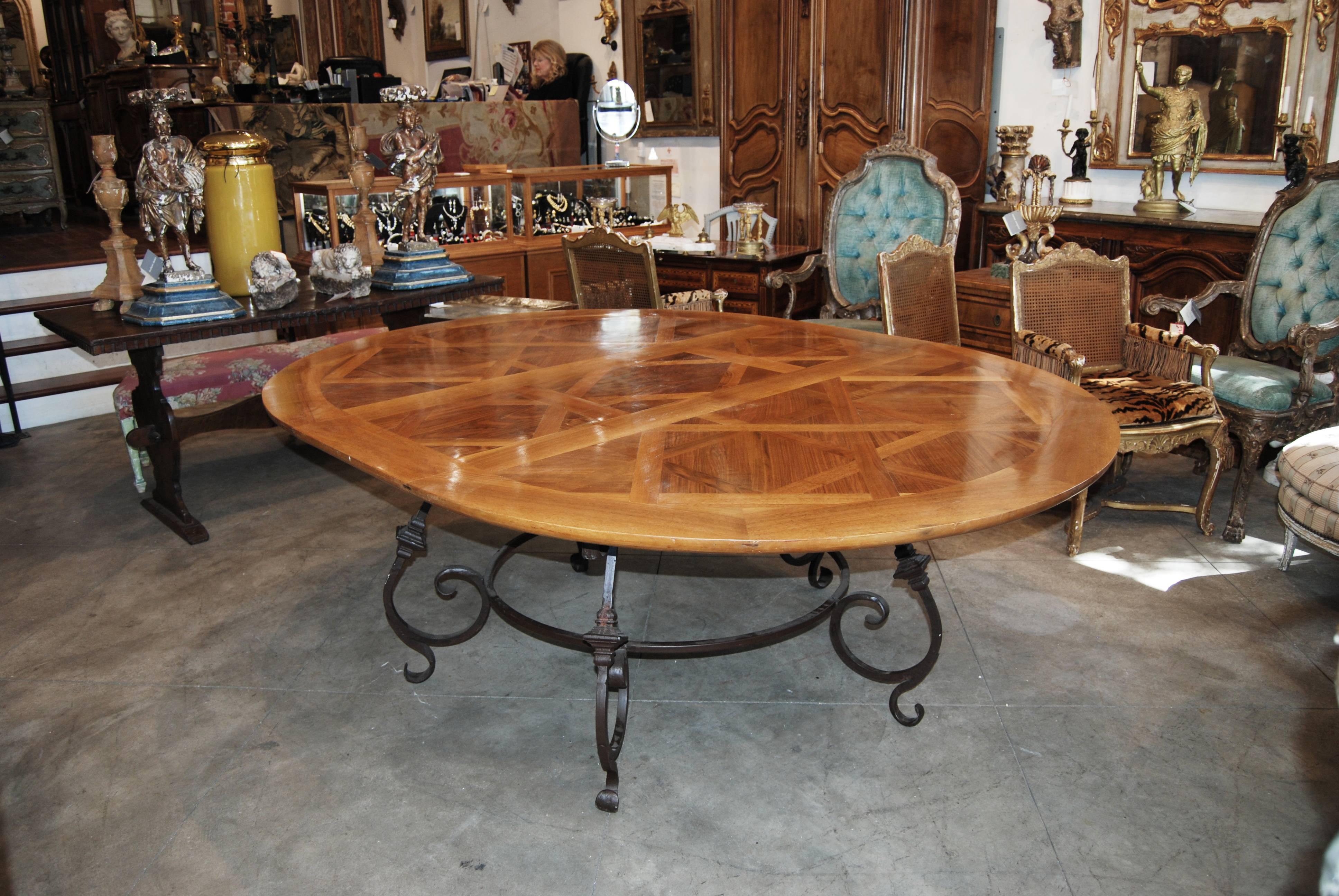 Beautiful oval Parquet de Versailles oval dining table with beautiful iron base.