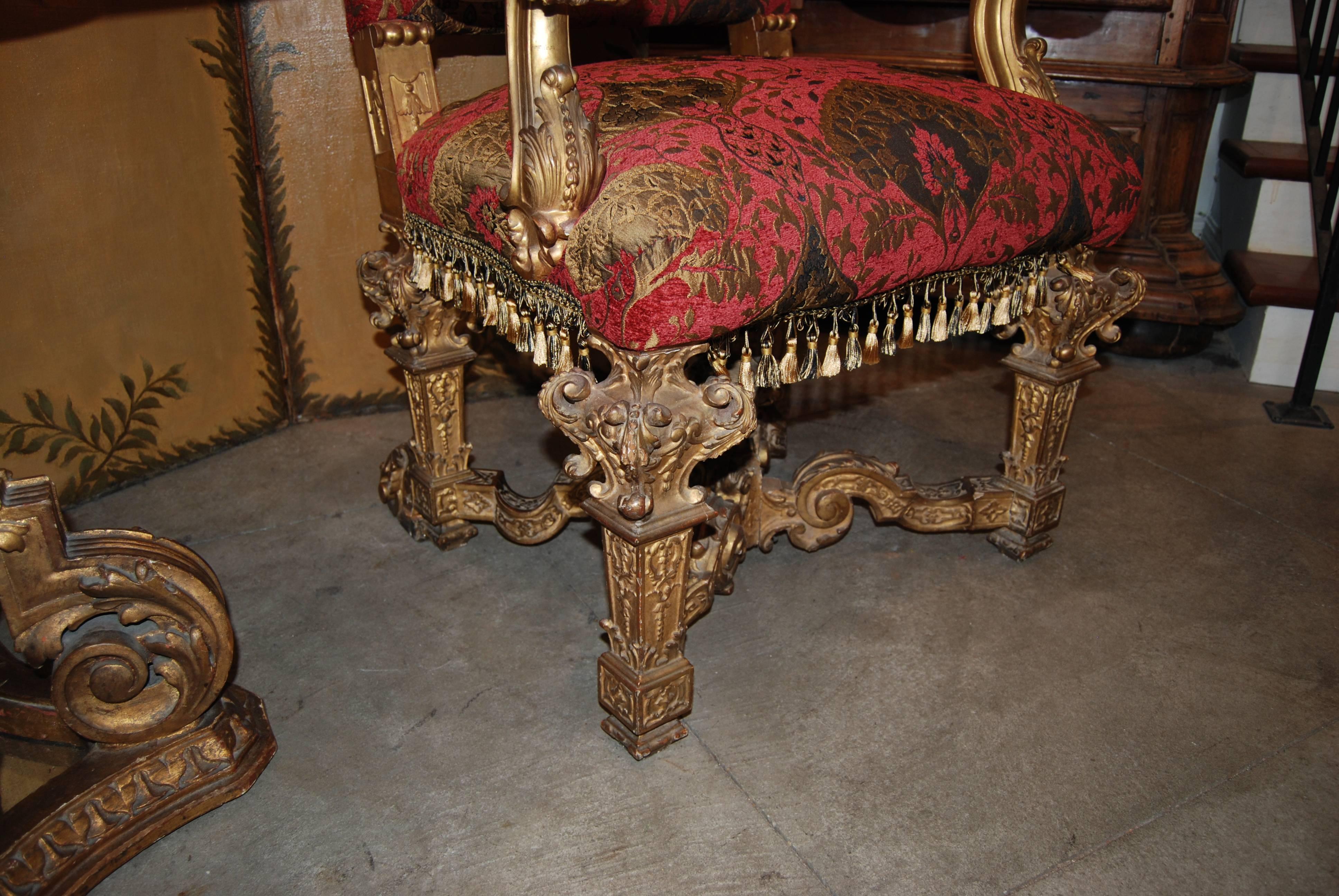 Pair of 18th century, carved and gilded armchairs.