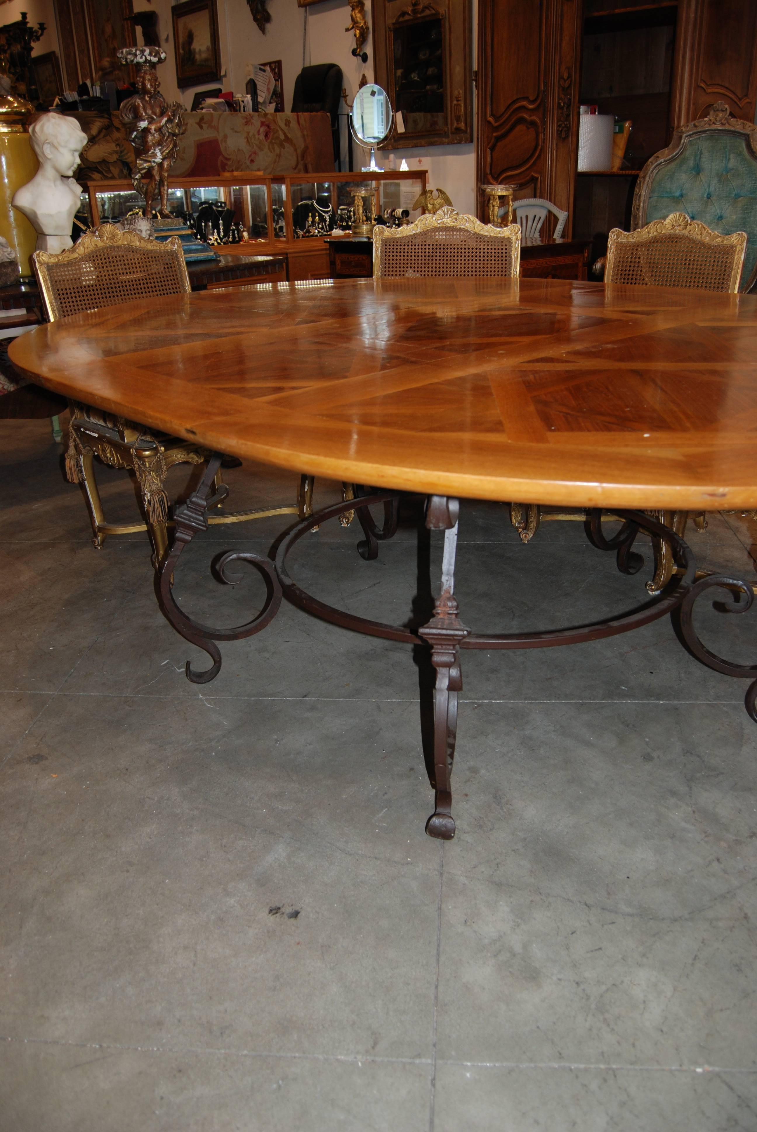 This table is made up of 18th century parquet flooring with an iron base.